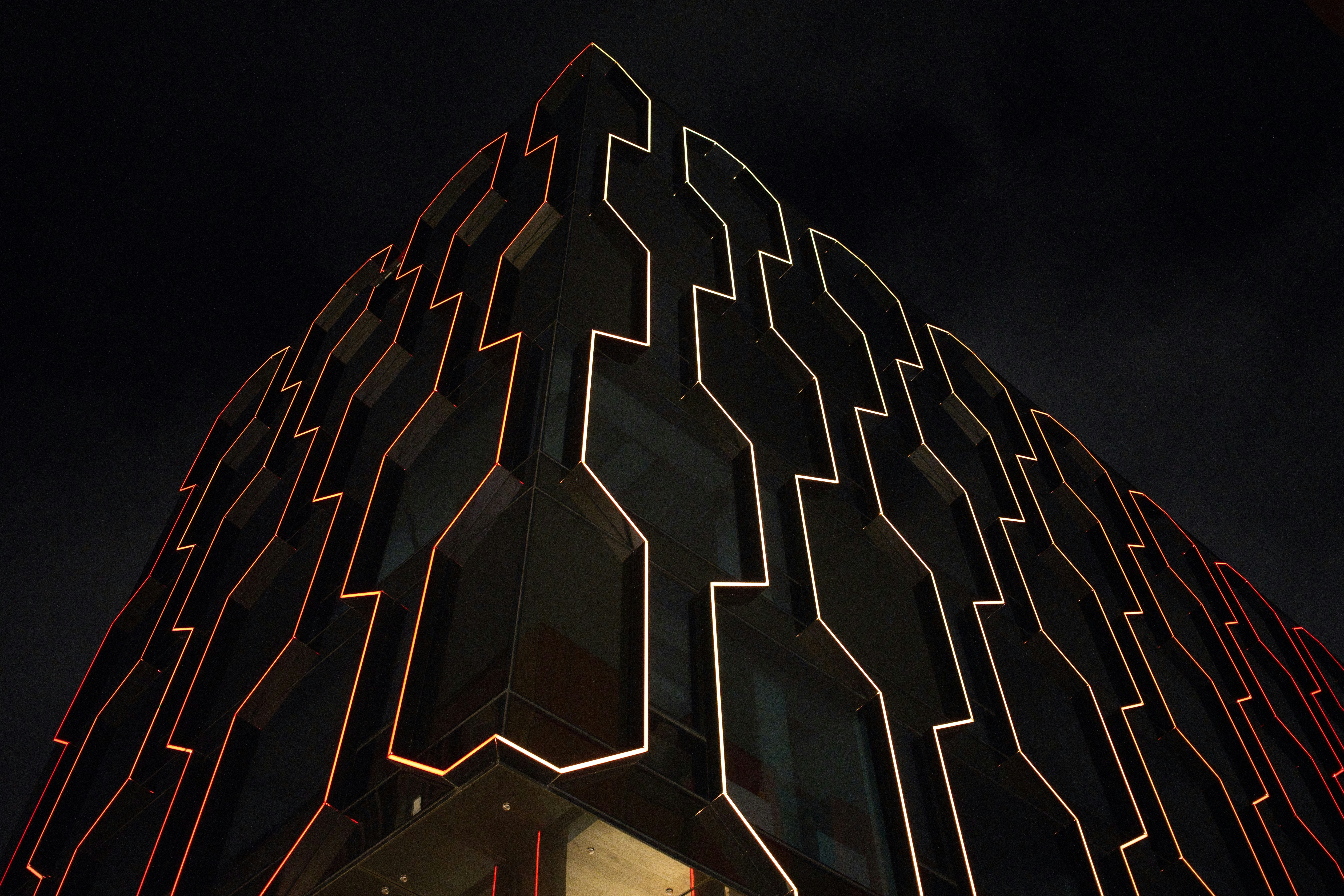 Modern building facade with geometric patterns at night