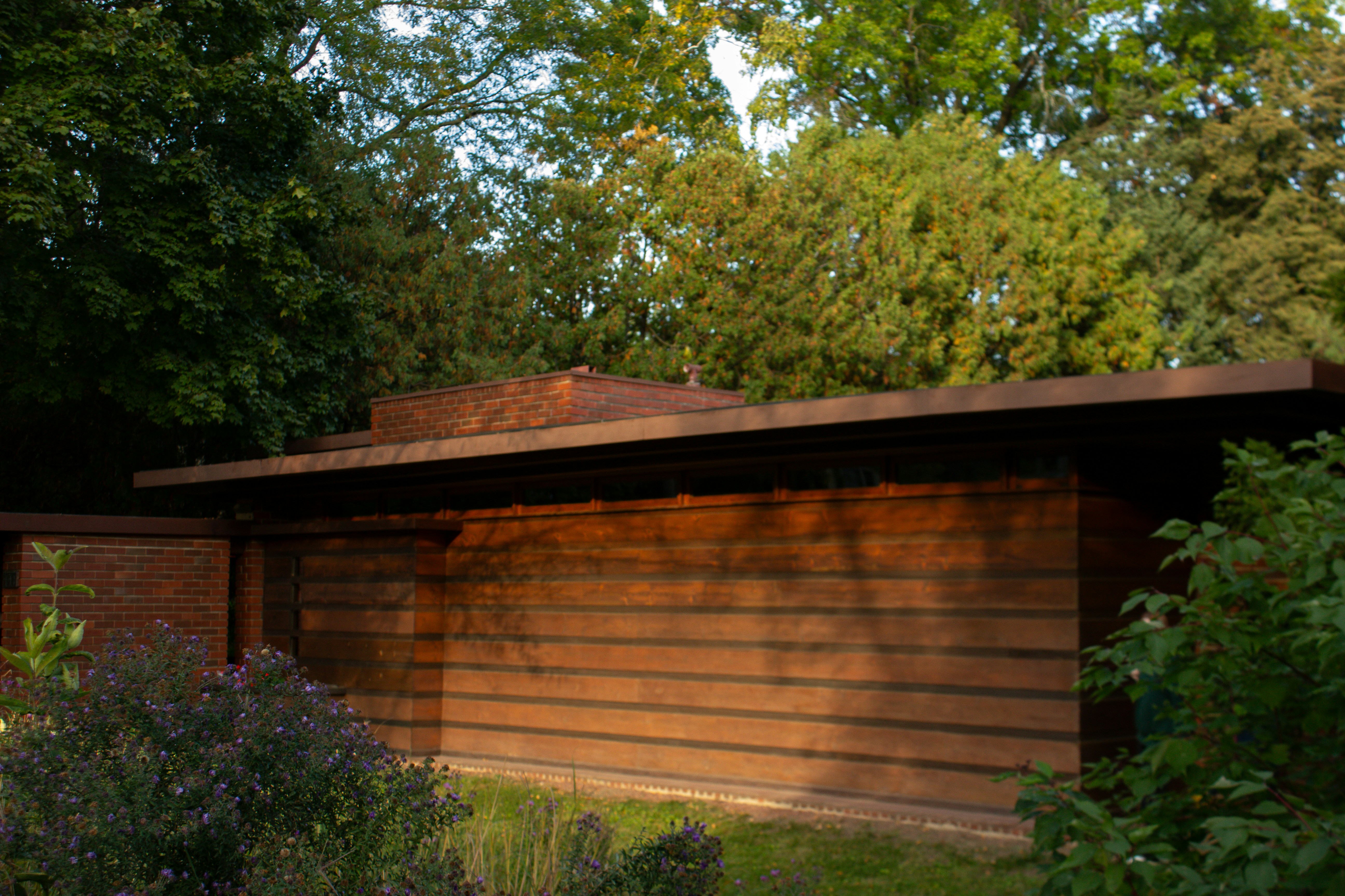 a house with a wooden roof and a brick chimney