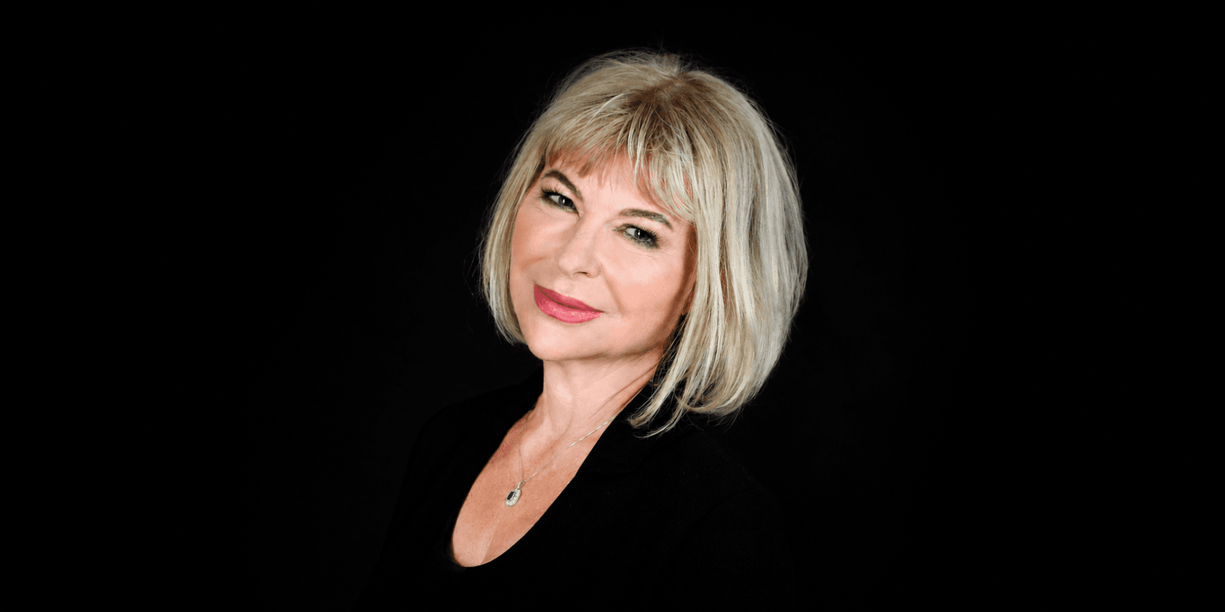 Portrait of Dr. Agnieszka Piotrowska against a black background.