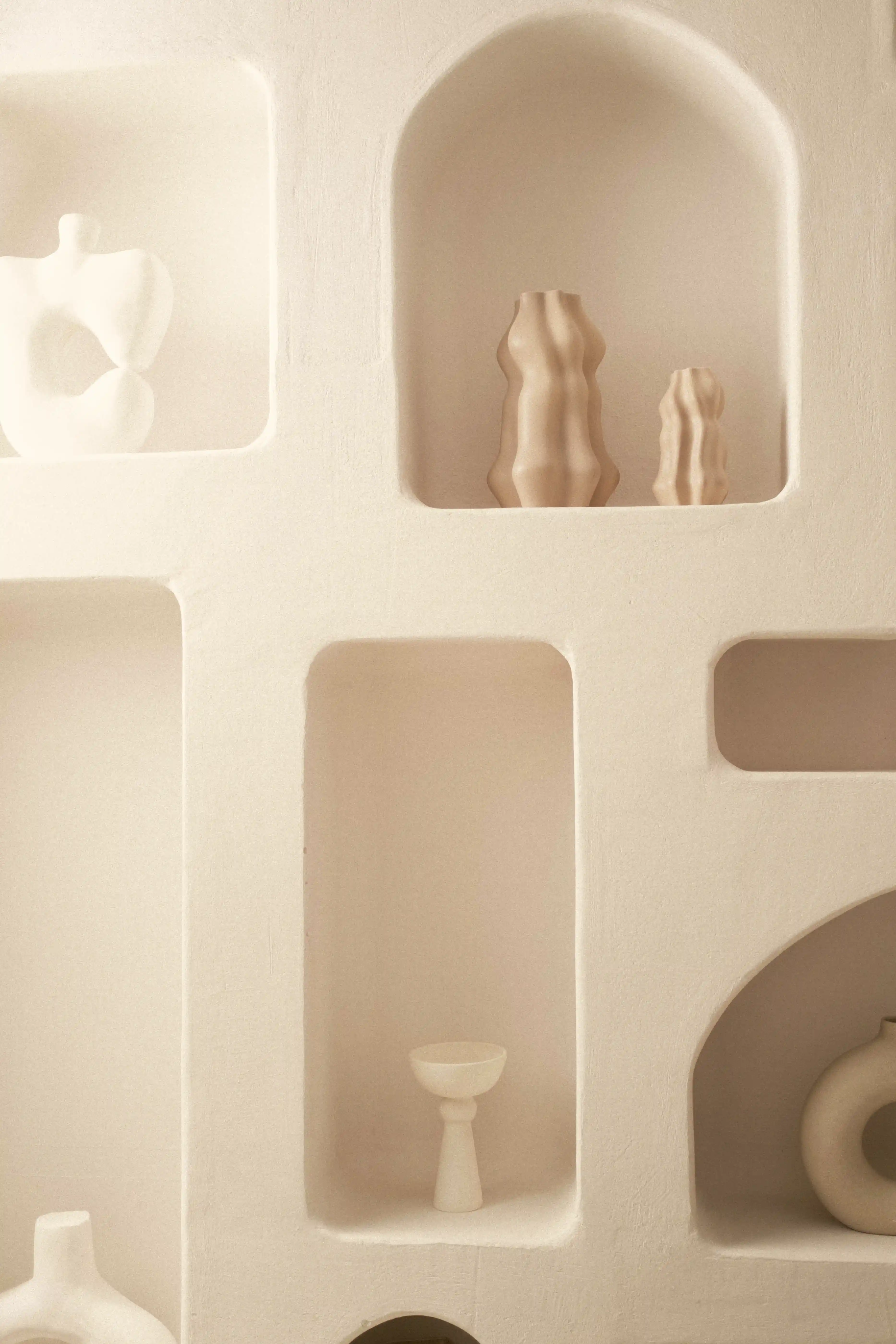 A close-up of a shelf with ceramic vases on it