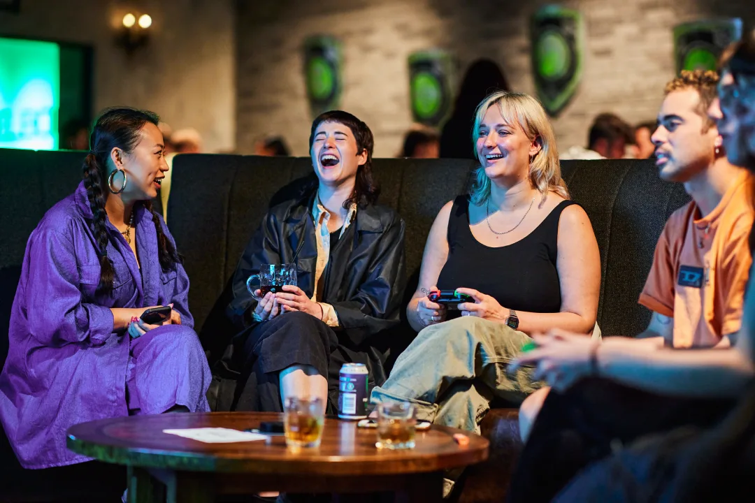 Group of 4 people sitting in a VIP booth in the Tavern