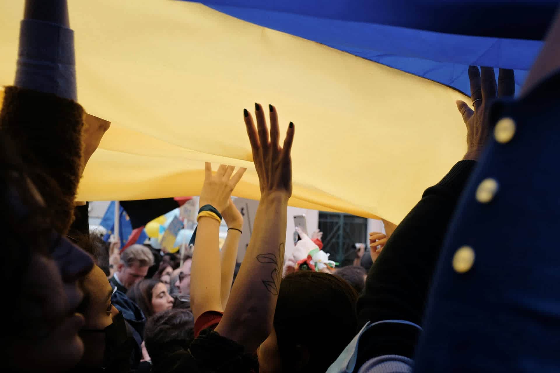 hands raising a flag
