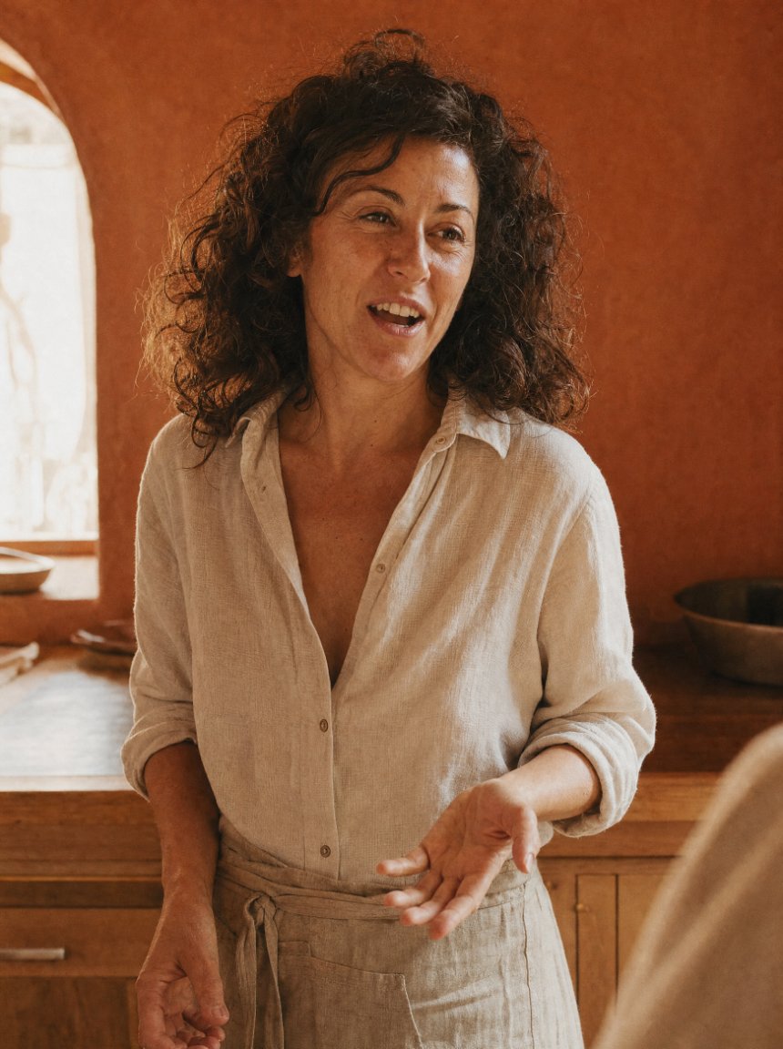 A partner mid-sentence in her kitchen