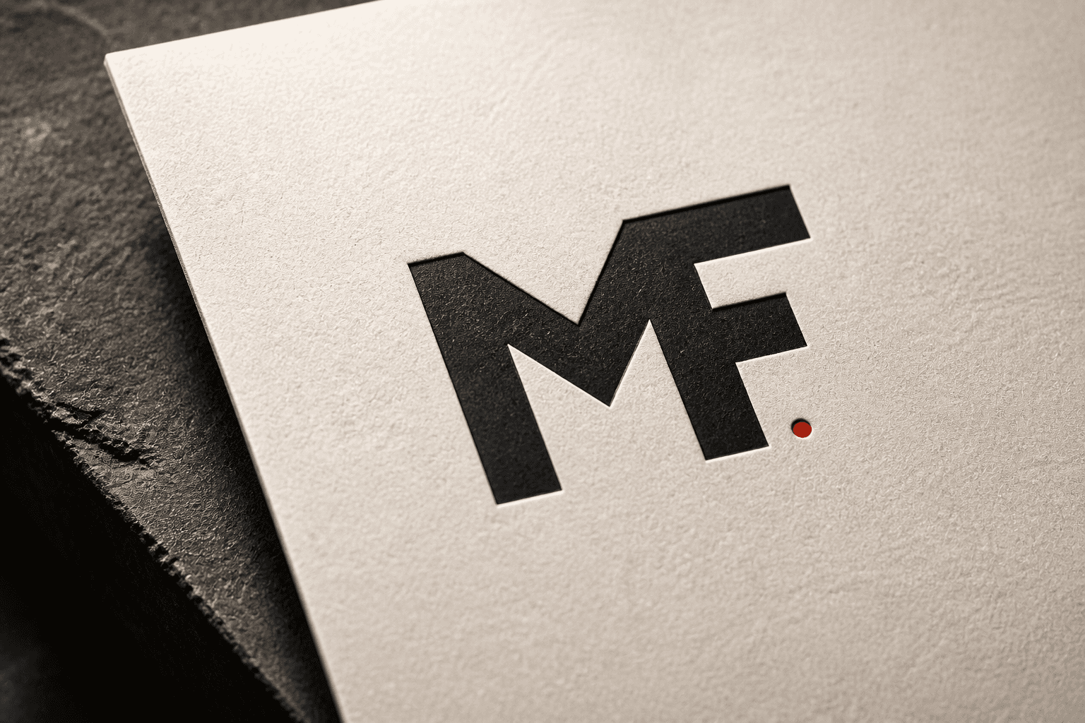 MF logo letterpress printed and embossed on a single sheet of textured paper