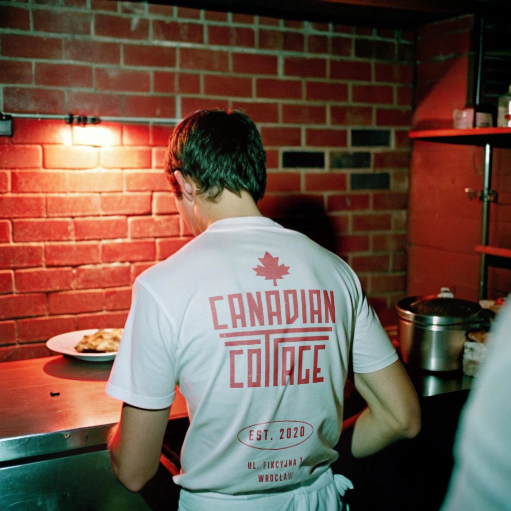 Cook witha logo on the back of his t-shirt