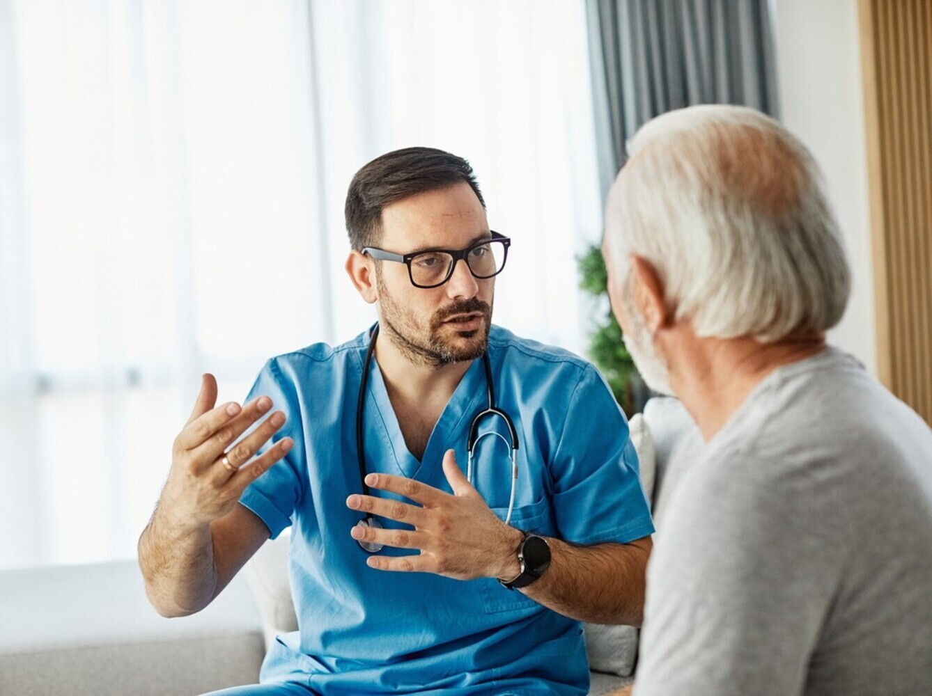 older man talking to his doctor about whether using an infrared sauna for weight loss is safe for him