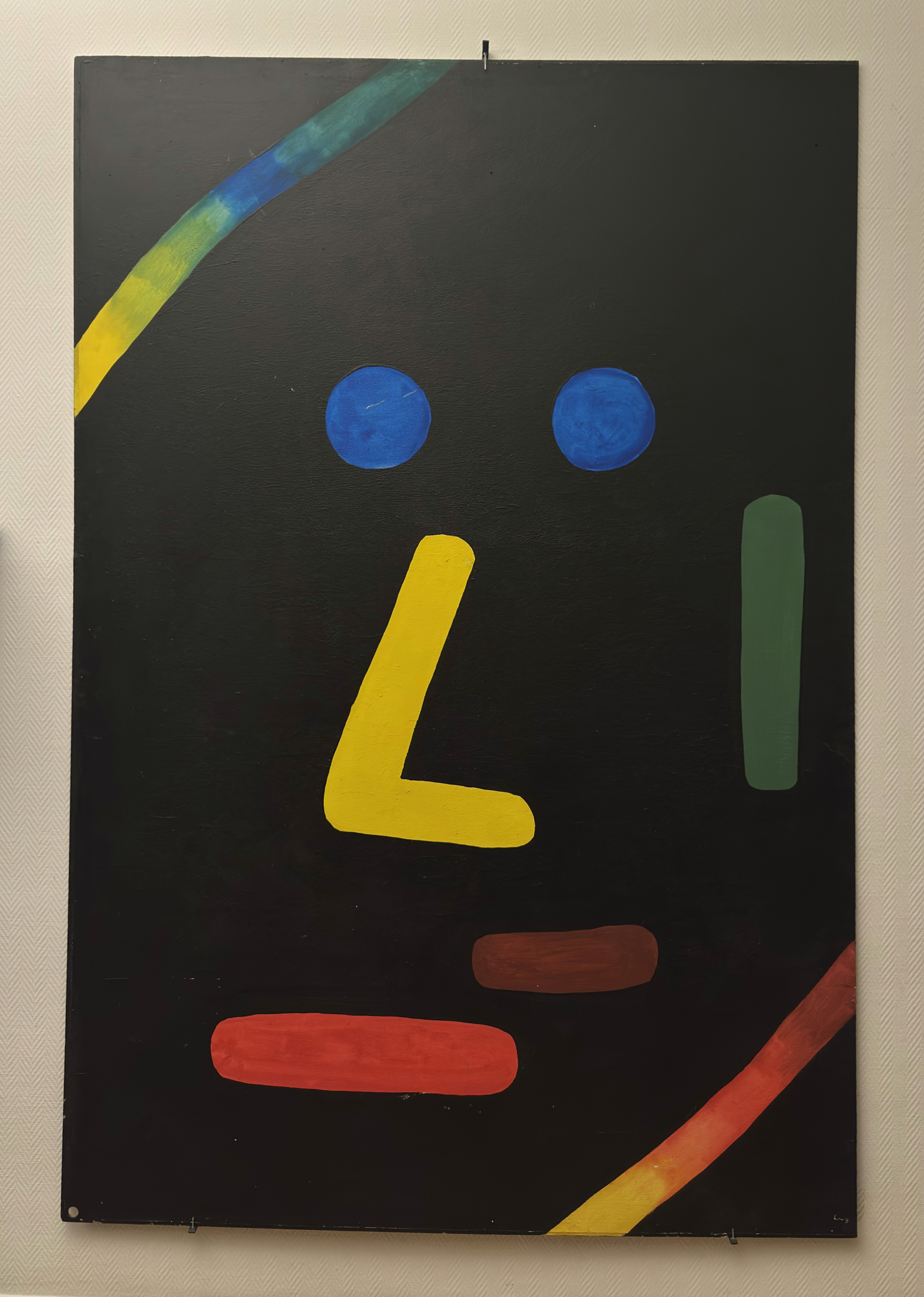 Close-up of a dark green leaf showing its textured surface and central vein against a muted background.