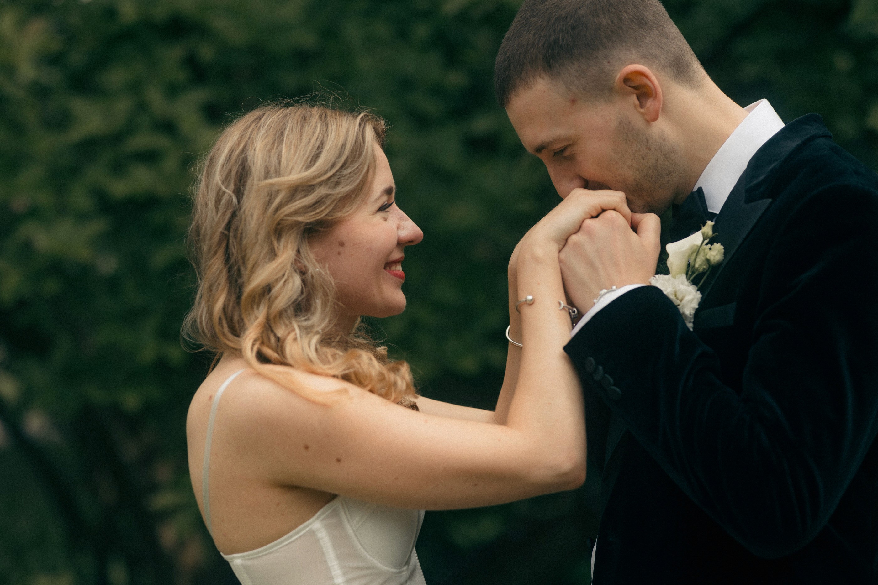 groom kissing brides hands
