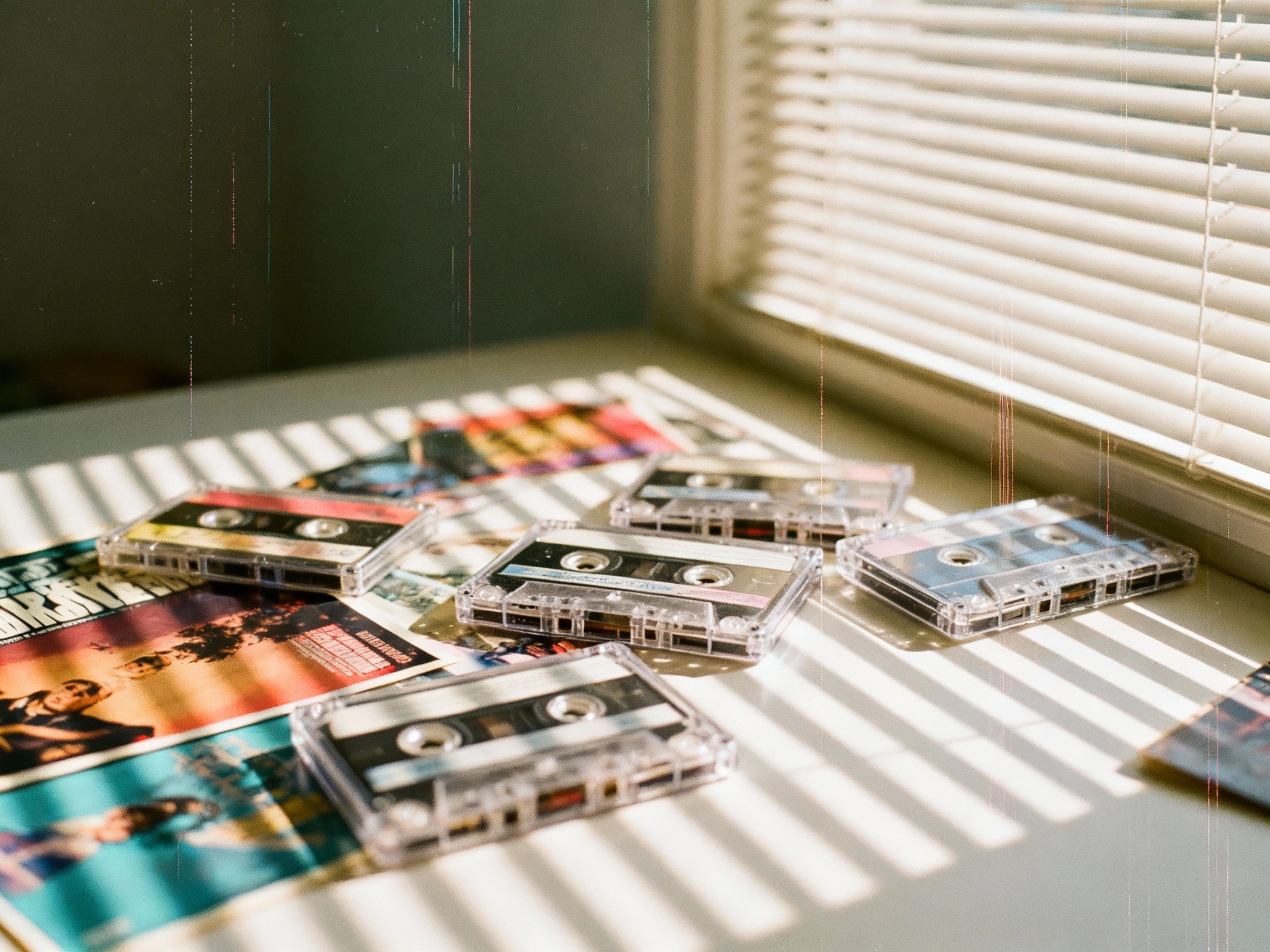 An editorial-style, photograph of a cluttered 1980s teenager's bedroom at midday