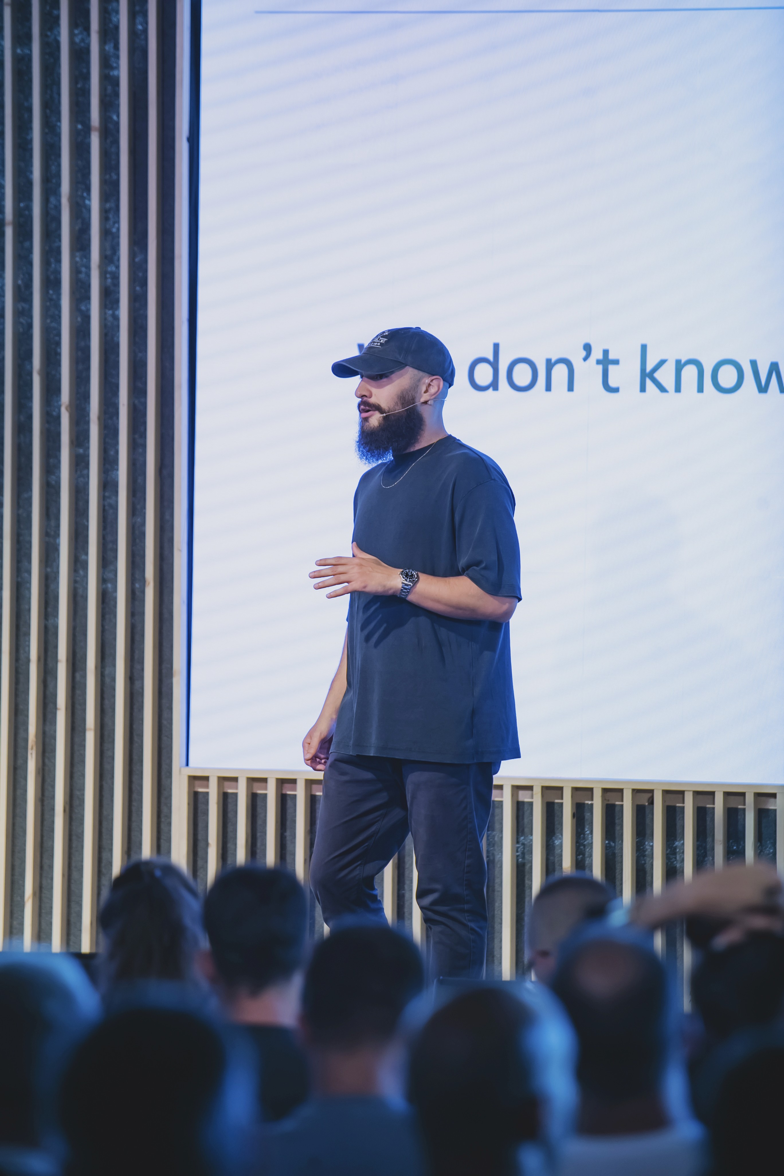 A thoughtful young person with dark hair gazes to the side, captured in soft black and white lighting.