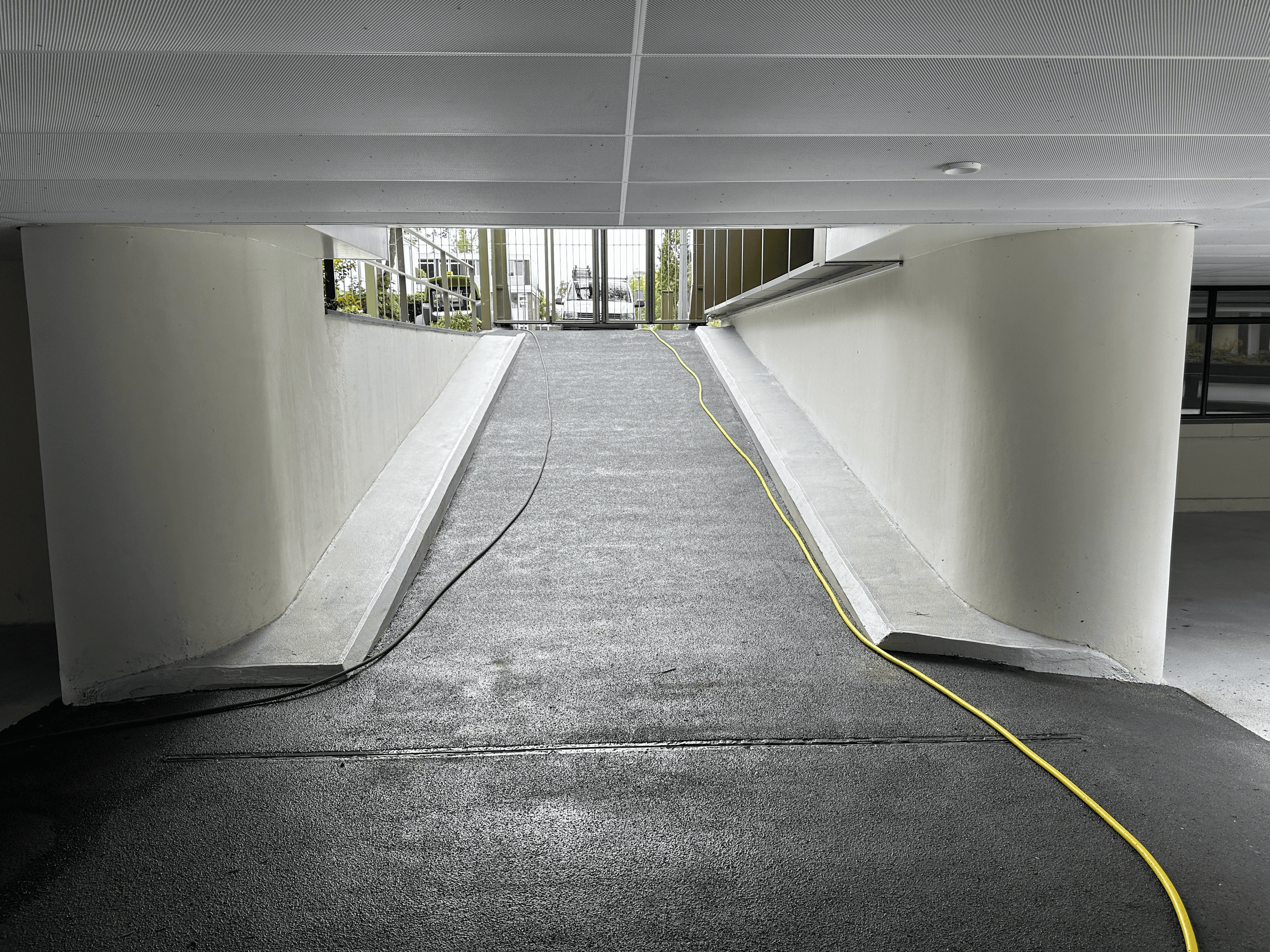 A diverse team collaborates around a table, analyzing documents and charts in a professional setting with a light green background.