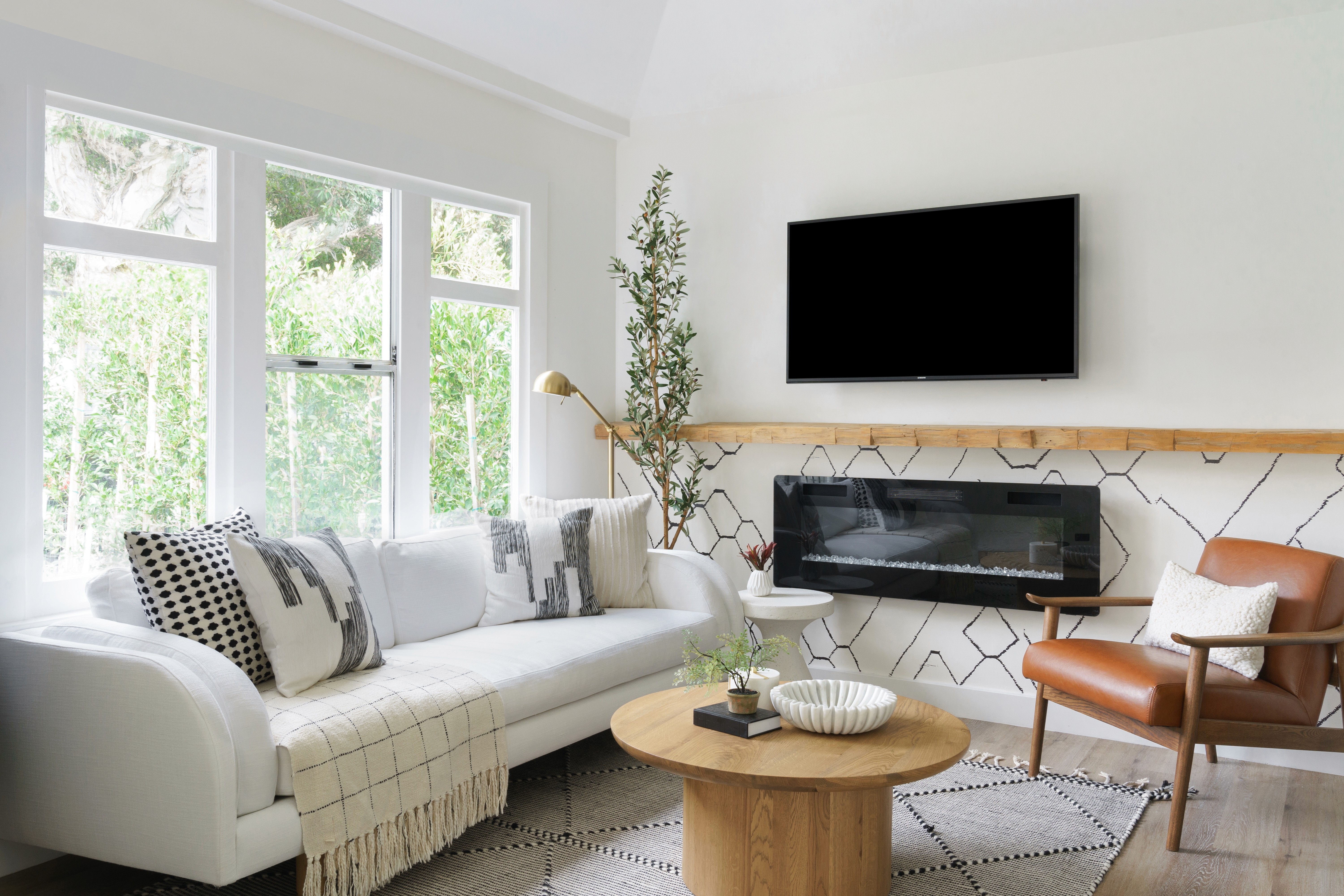 A Modern and inviting contemporary living room design featuring warm earth tones and natural textures