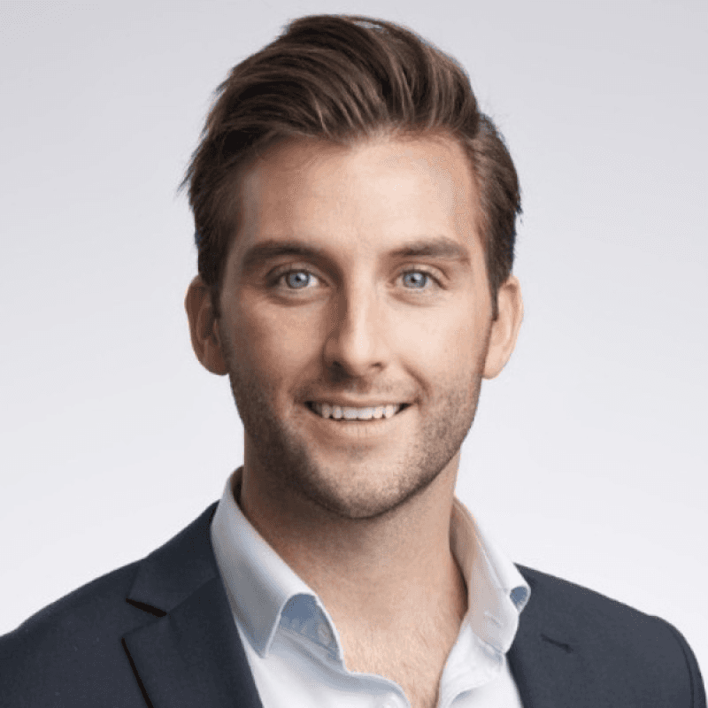 woman in red long sleeve shirt standing near white wall during daytime