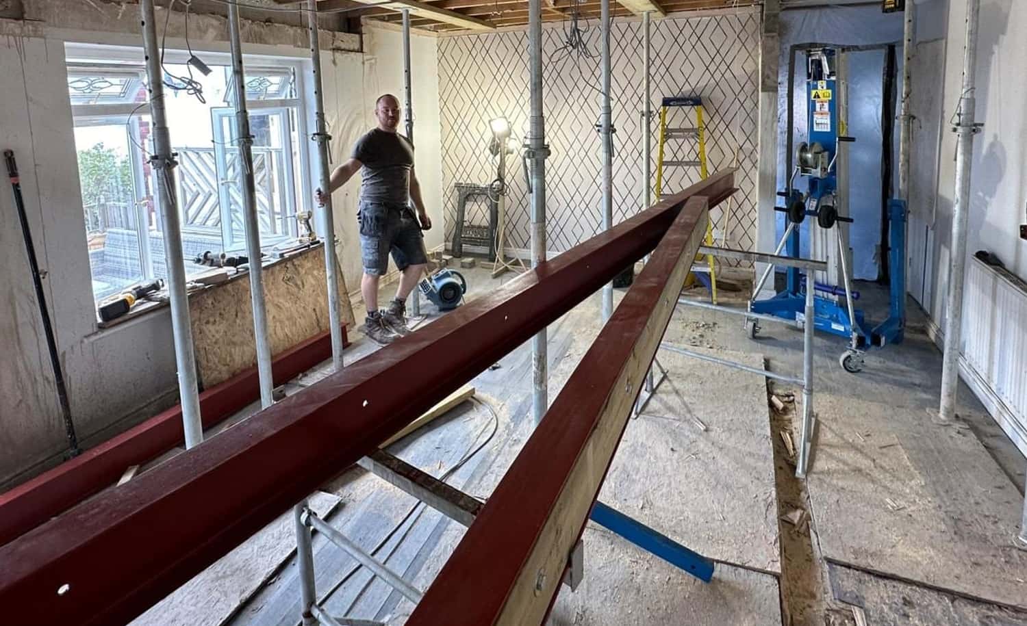 A steel beam ready to go in, with the ceiling propped