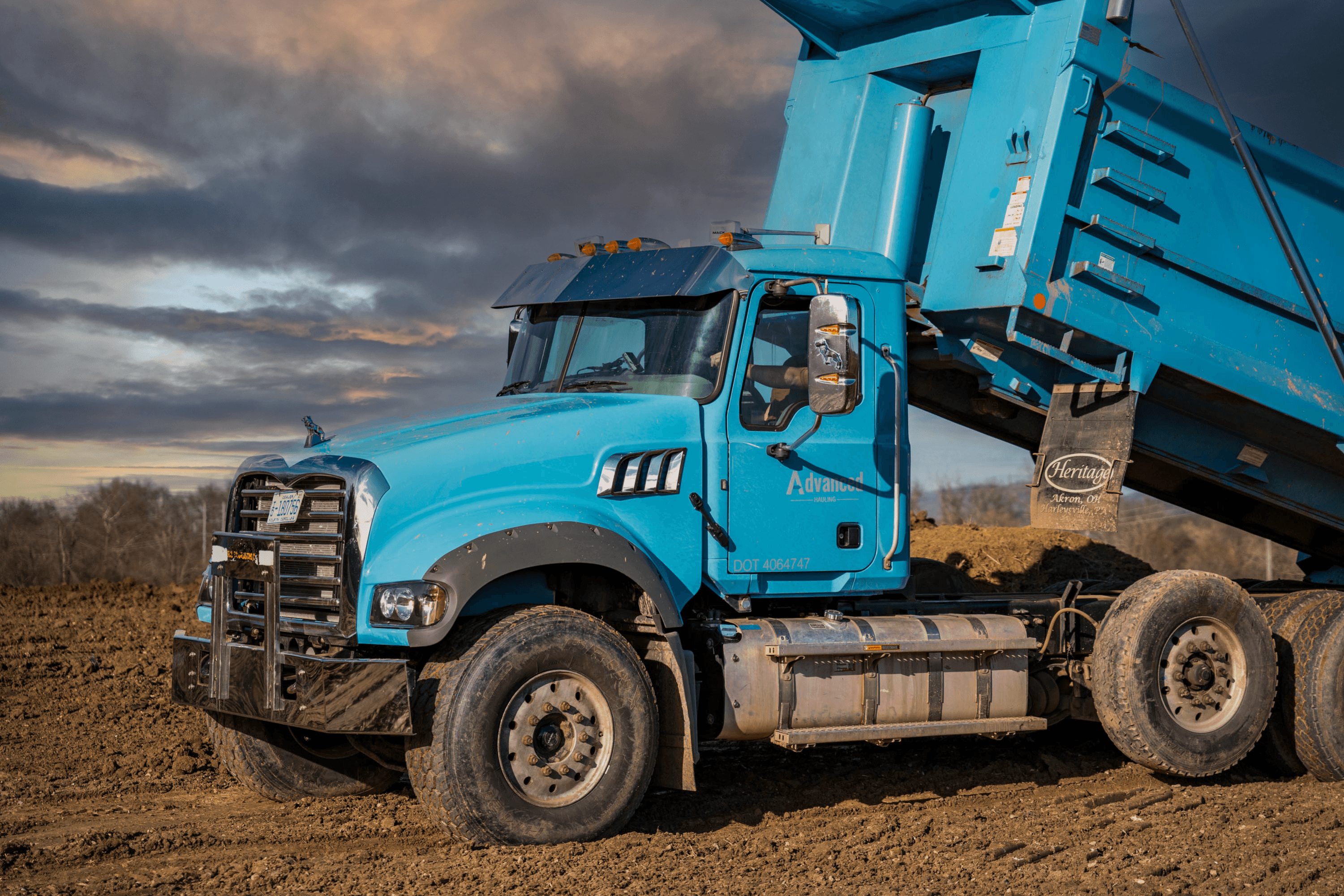 DUMP TRUCK UNLOADING A LOAD OF ROCKS