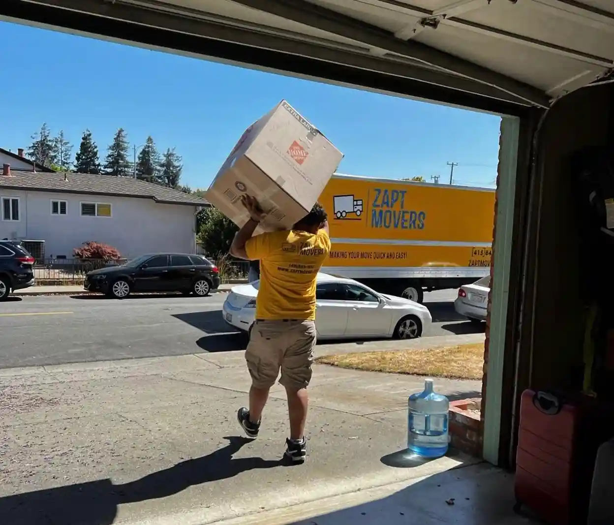 Zapt Movers professional carrying boxes from a residential property