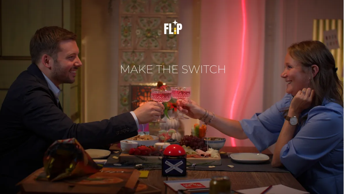 Brand advertisement shot of a couple toasting drinks with the slogan "MAKE THE SWITCH" overlaid.