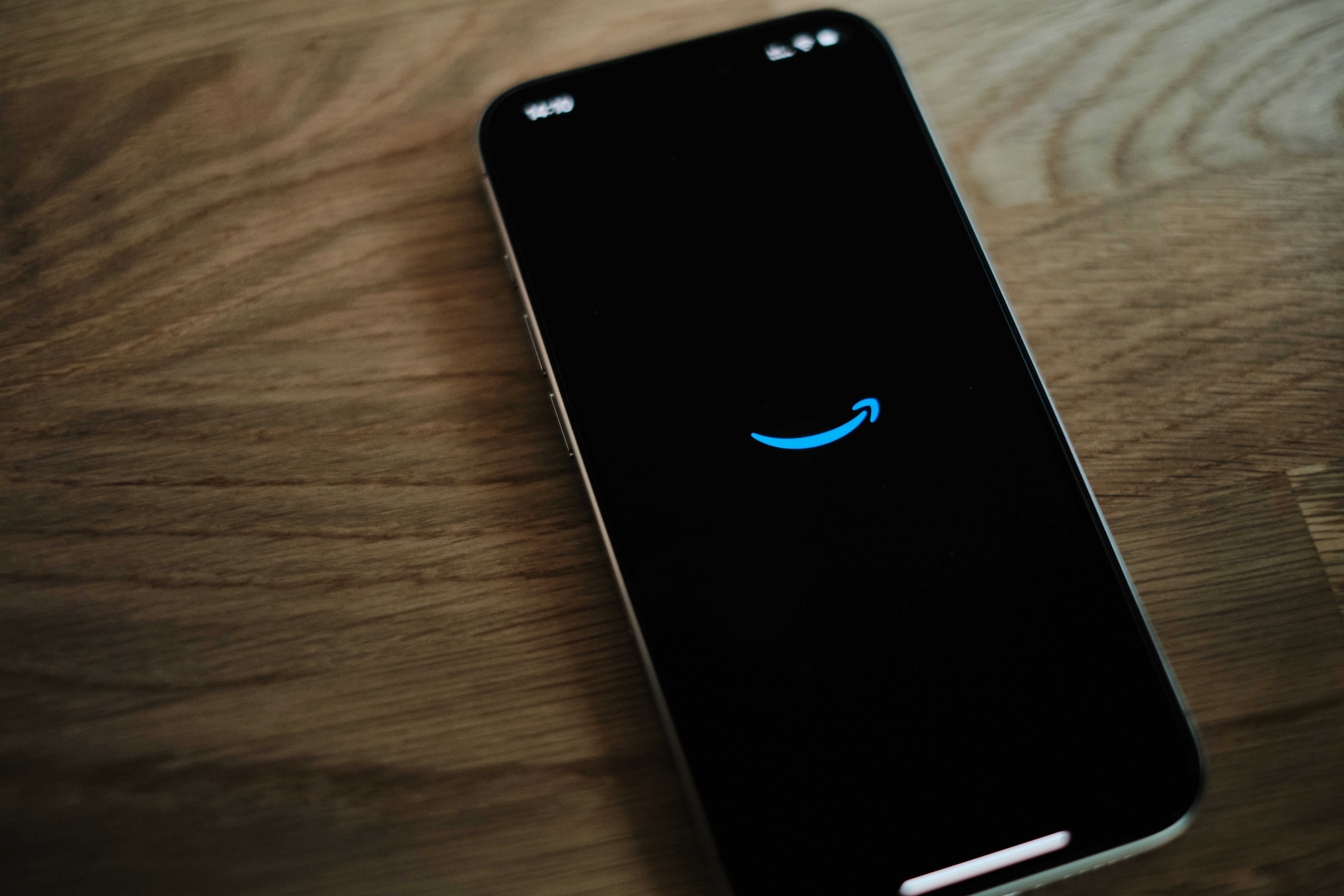 A black cell phone with a blue smiley face on it