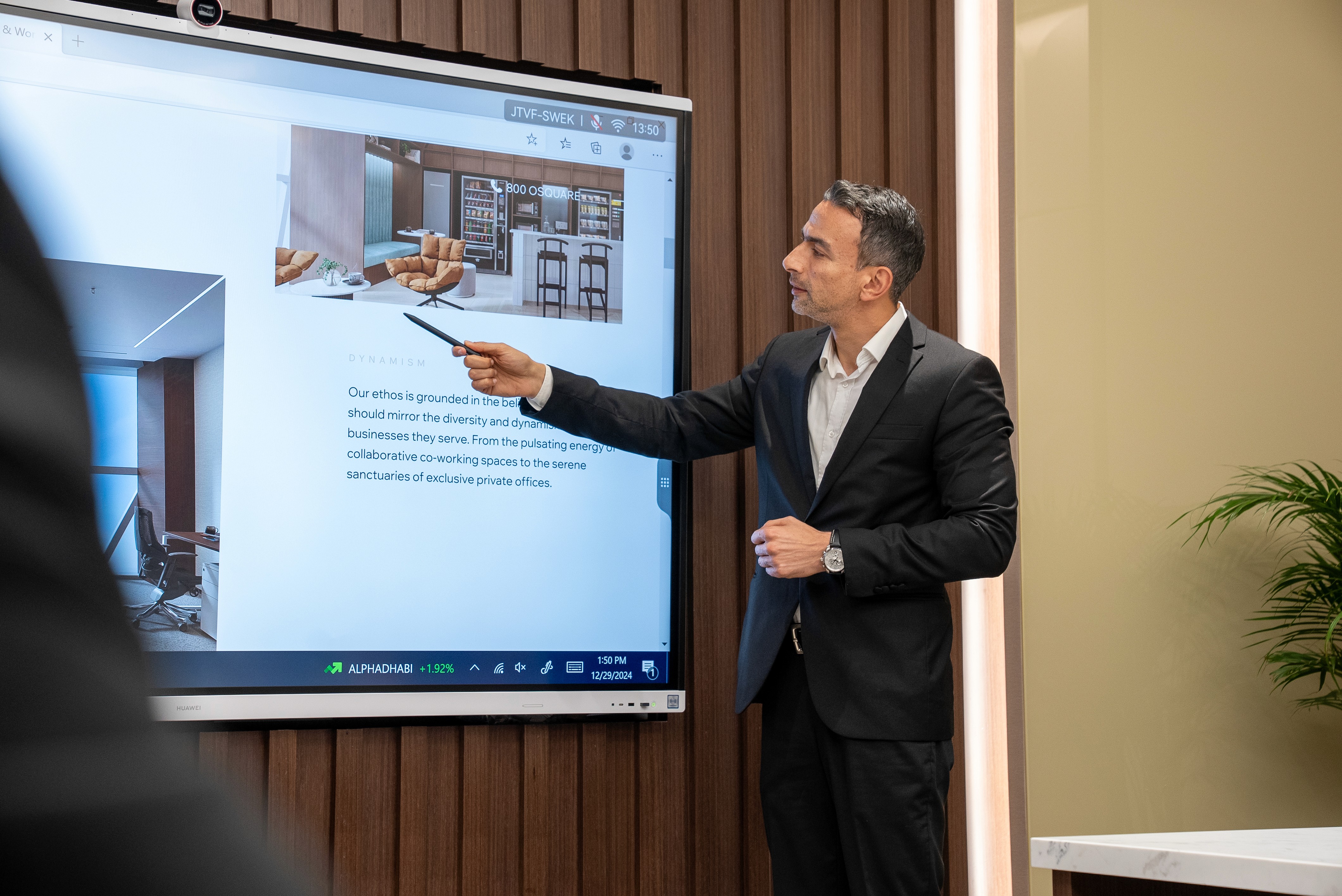 A sophisticated private meeting room with warm lighting, a refined wooden table, and executive chairs.