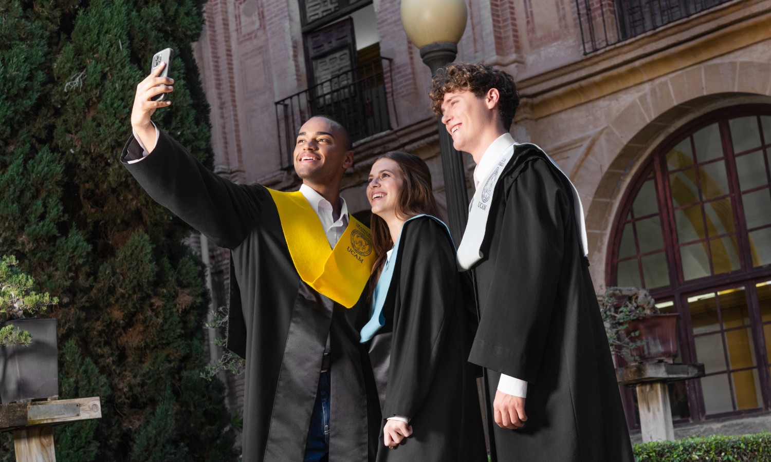 man in academic dress wearing mortar cap