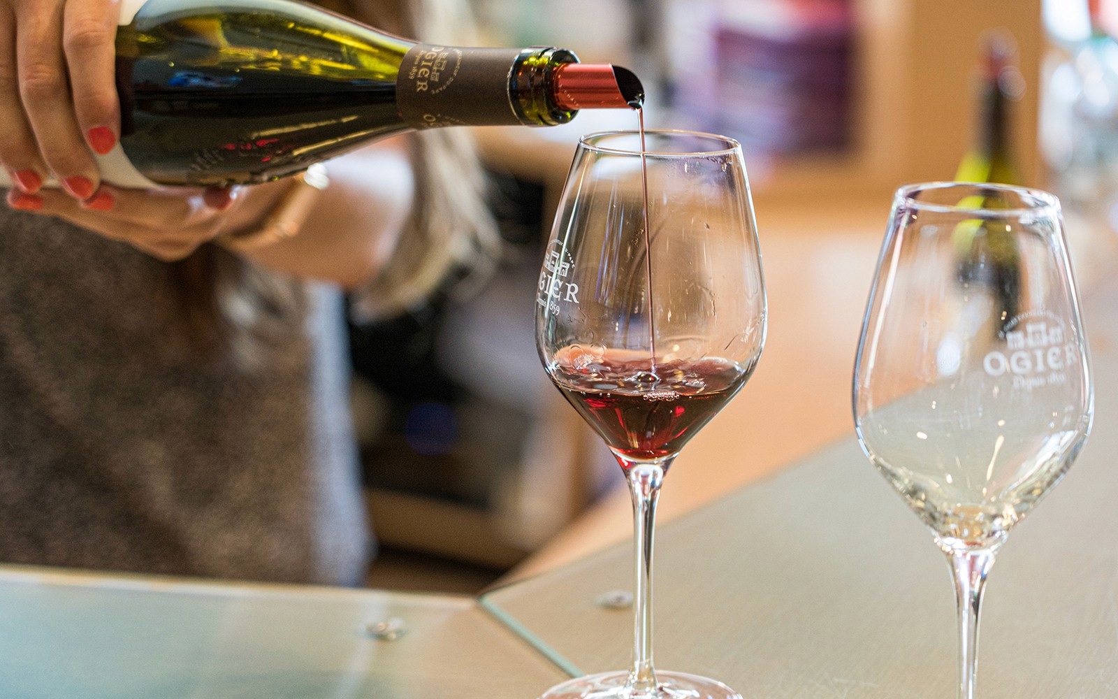 Pouring red wine into a glass during a wine tour in Avignon, France.