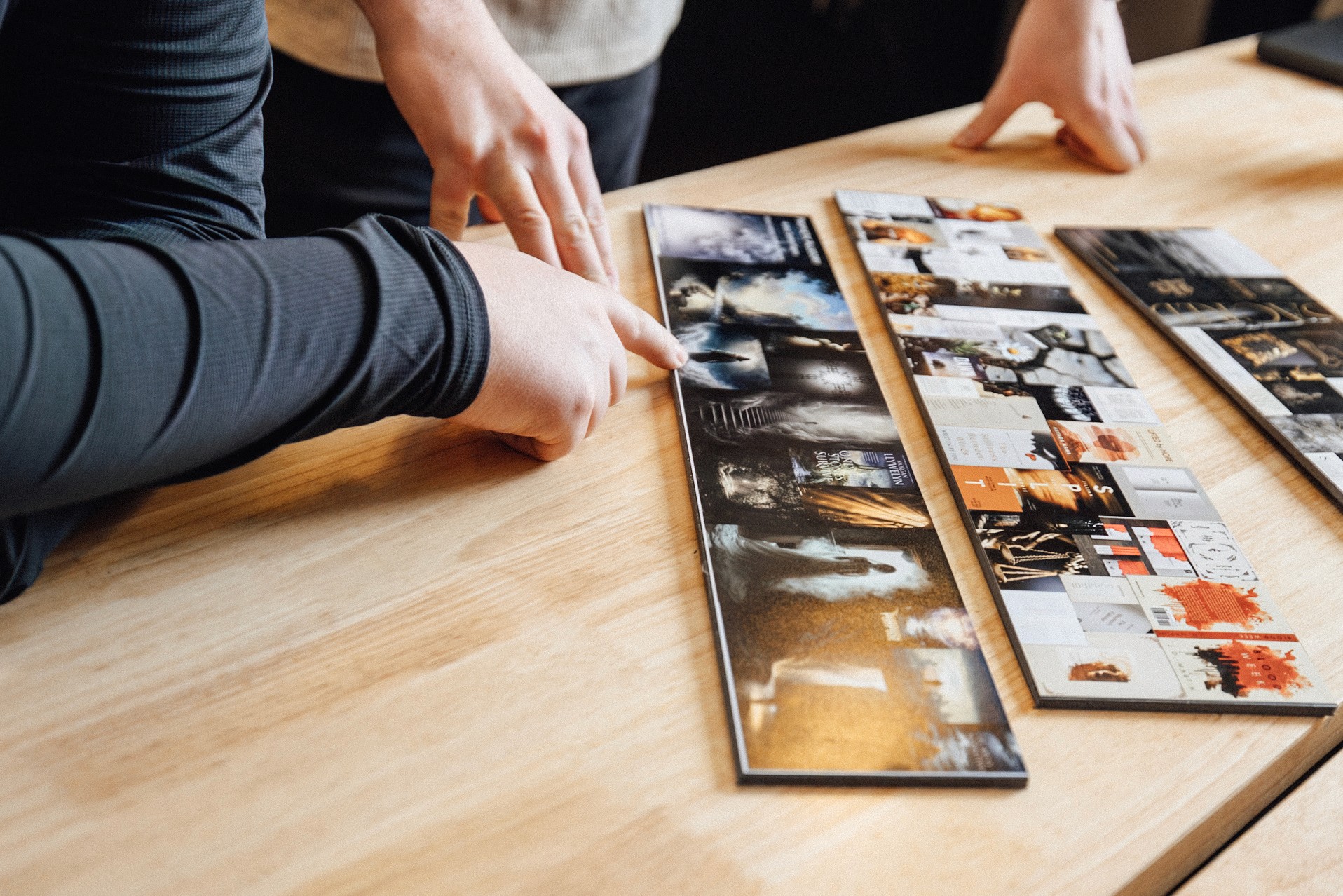 Photo of team members collaborating over a set of stylescapes on a wooden table
