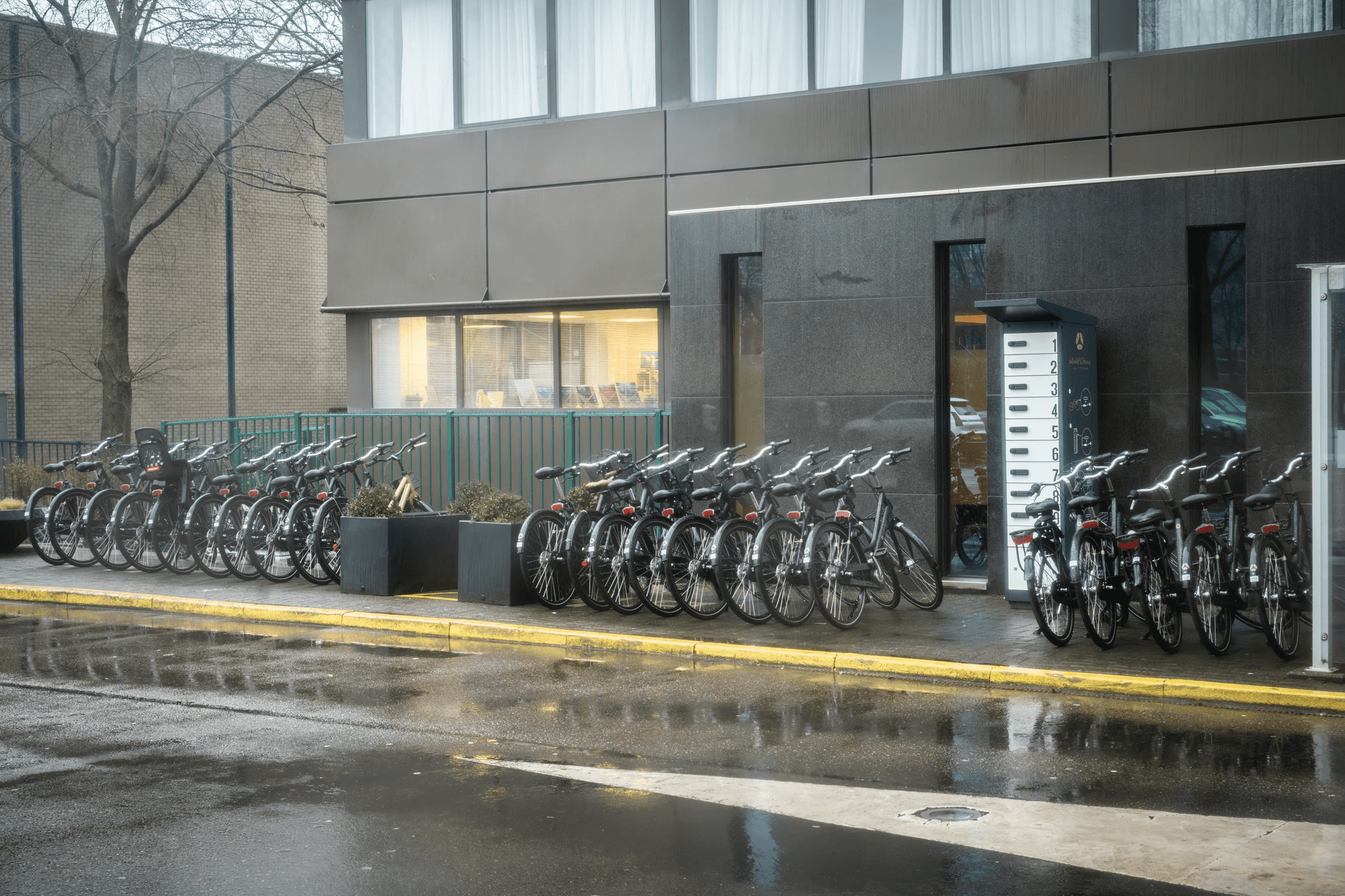 PowerShelter's CoreShelter charging locker installed outside Hotel Okura Amsterdam, next to the hotel's bike parking for guests.