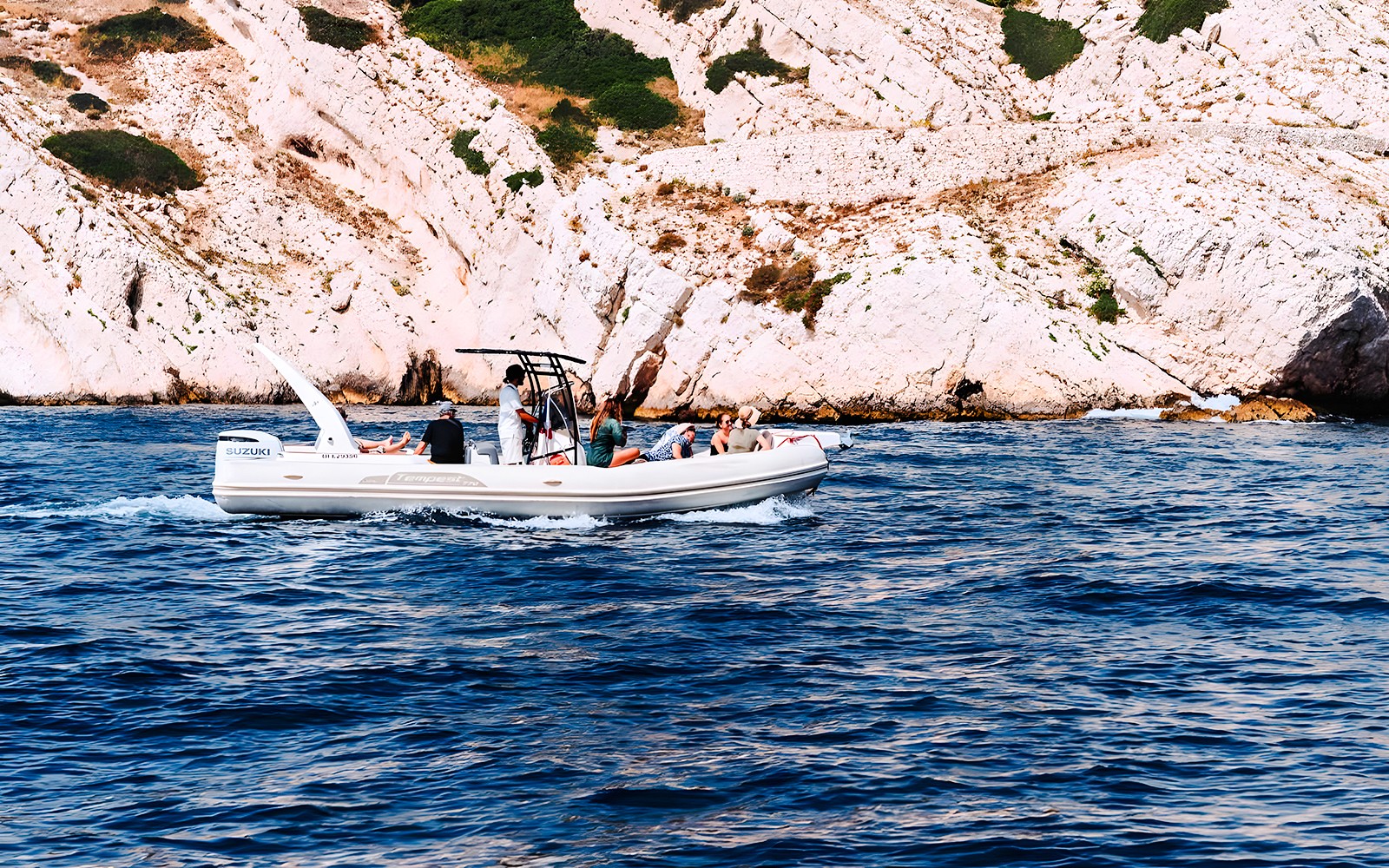 Boat tour along rocky coastline in Marseille, France.