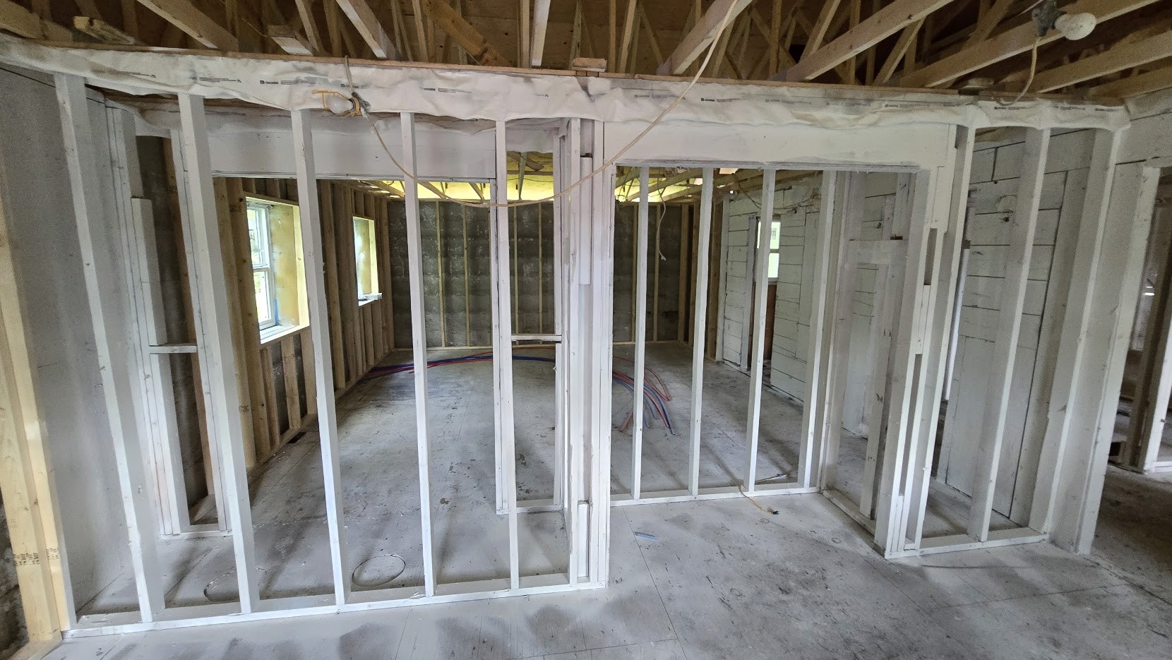 Building under construction showing exposed metal framing without walls