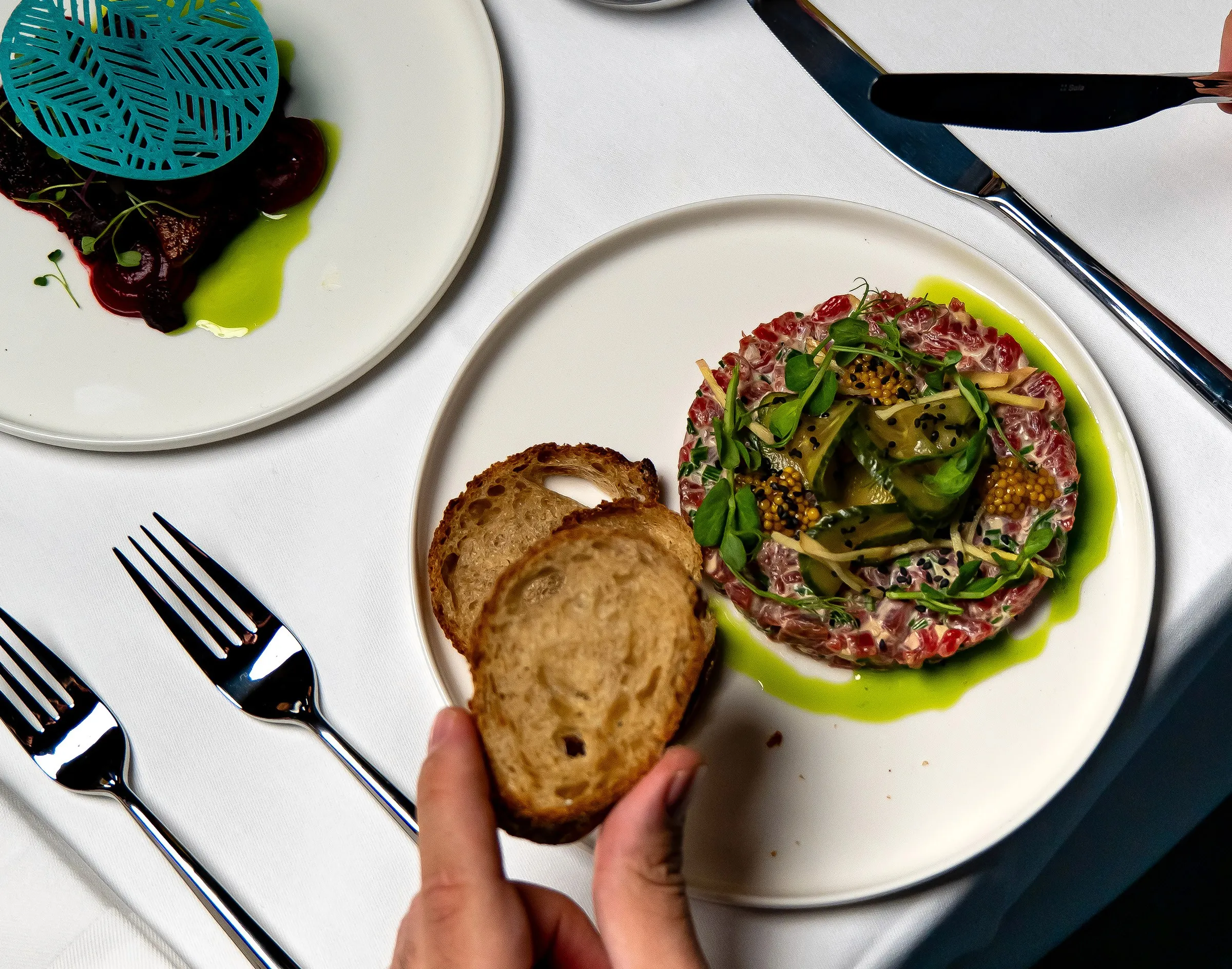 two people looking at a tablet and smiling