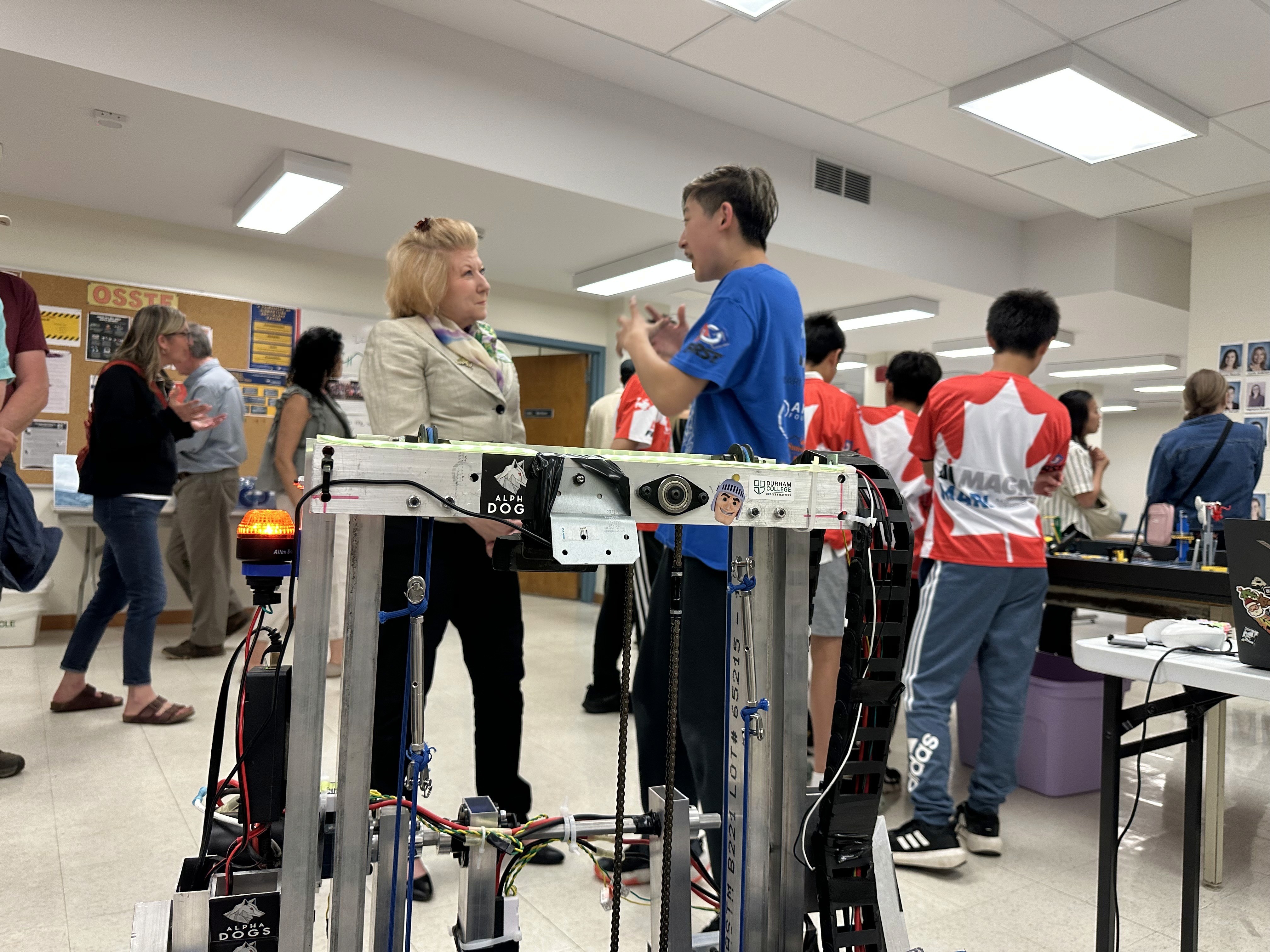 FRC team 10015 Bubbles Team Captain Ryan Zhang showcases their 2025 season robots to Alumni of Dr. G.W. Williams SS