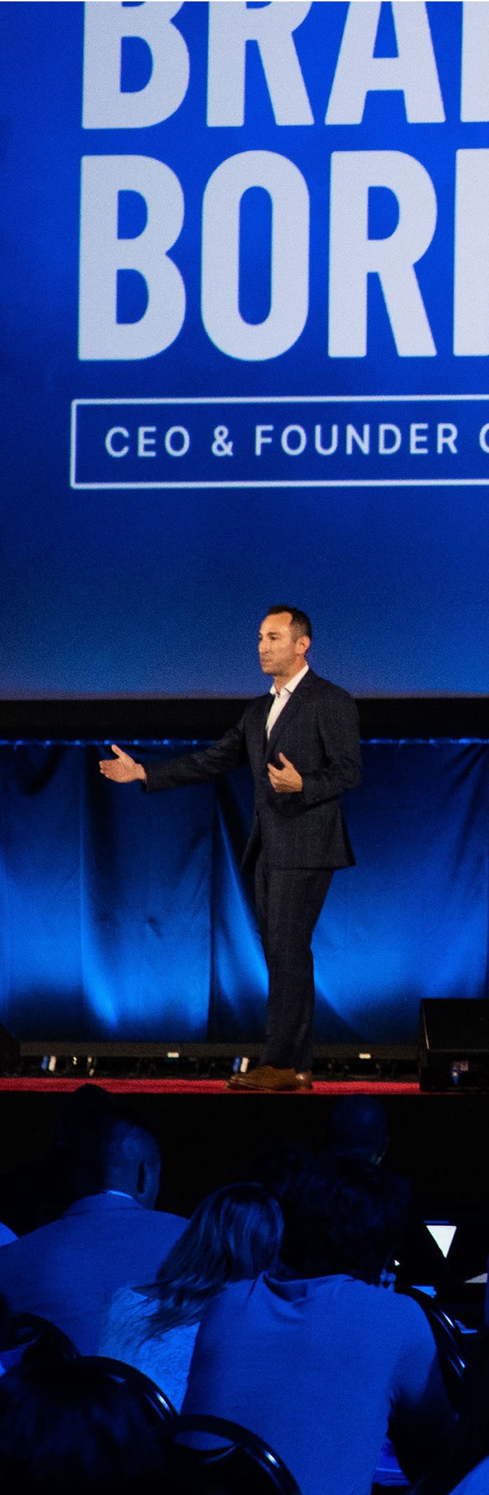 Brandon speaking to an audience at a conference
