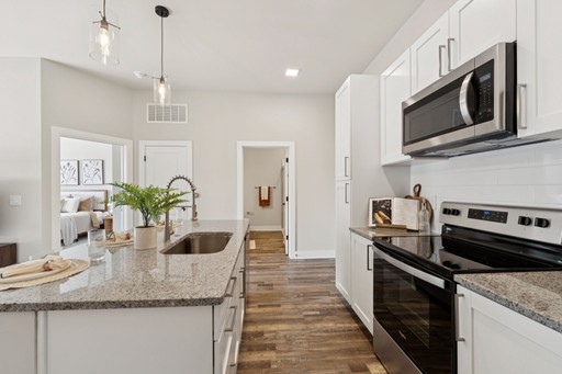 A stylish kitchen with sleek stainless steel appliances and polished granite countertops.