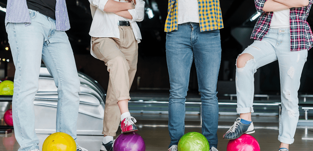 Men standing with bowling balls