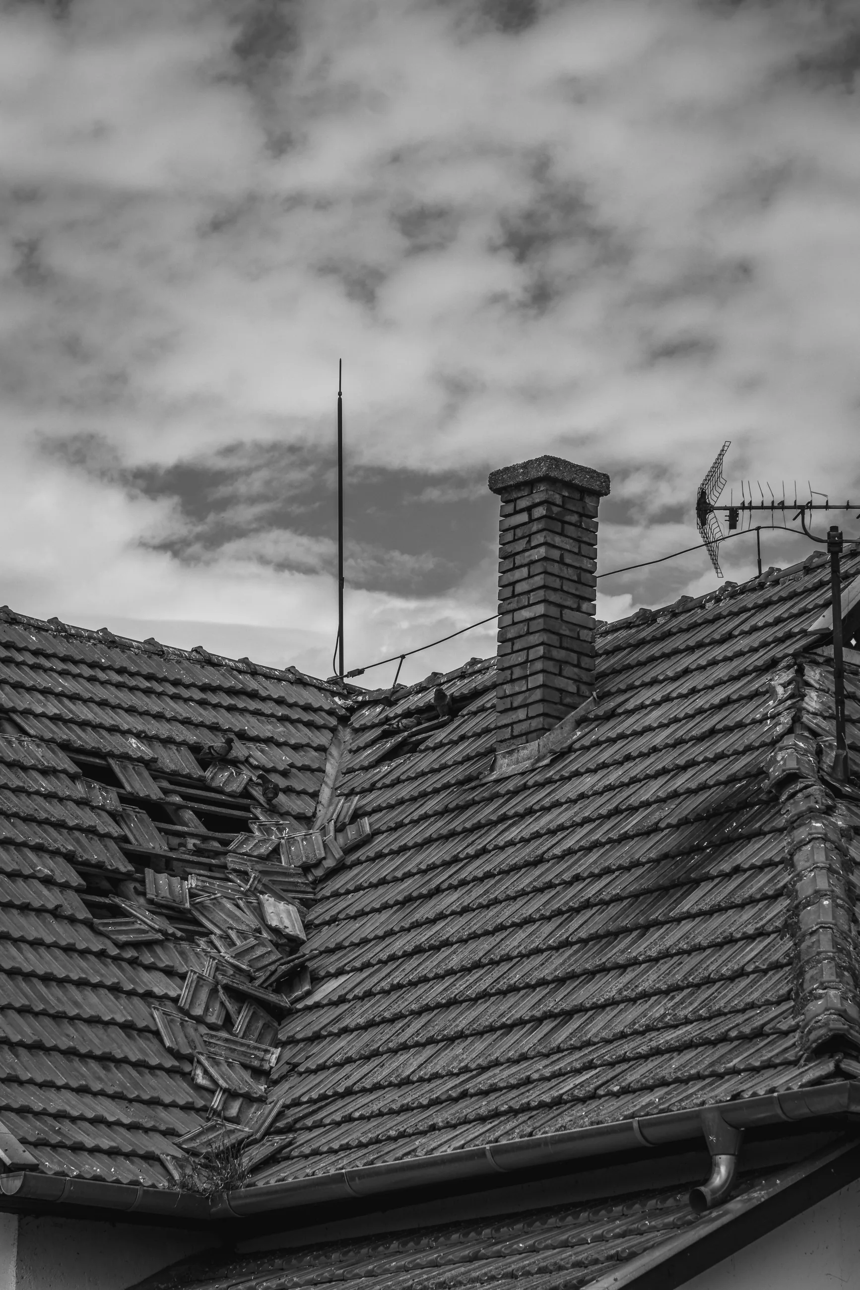 Roof with storm damage being assessed for repair