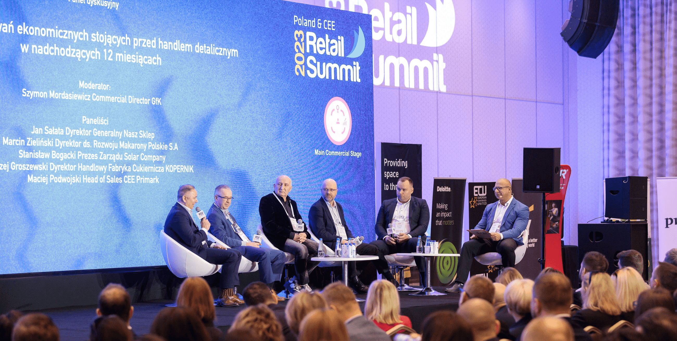 Speakers addressing a conference audience