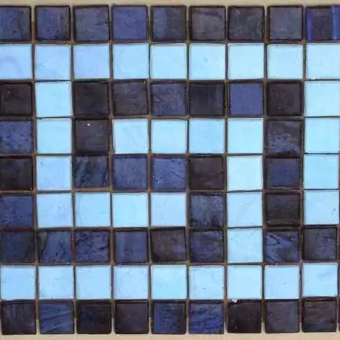 Mosaic pool border with Greek and Roman-inspired mosaic tiles in blue and dark tones.