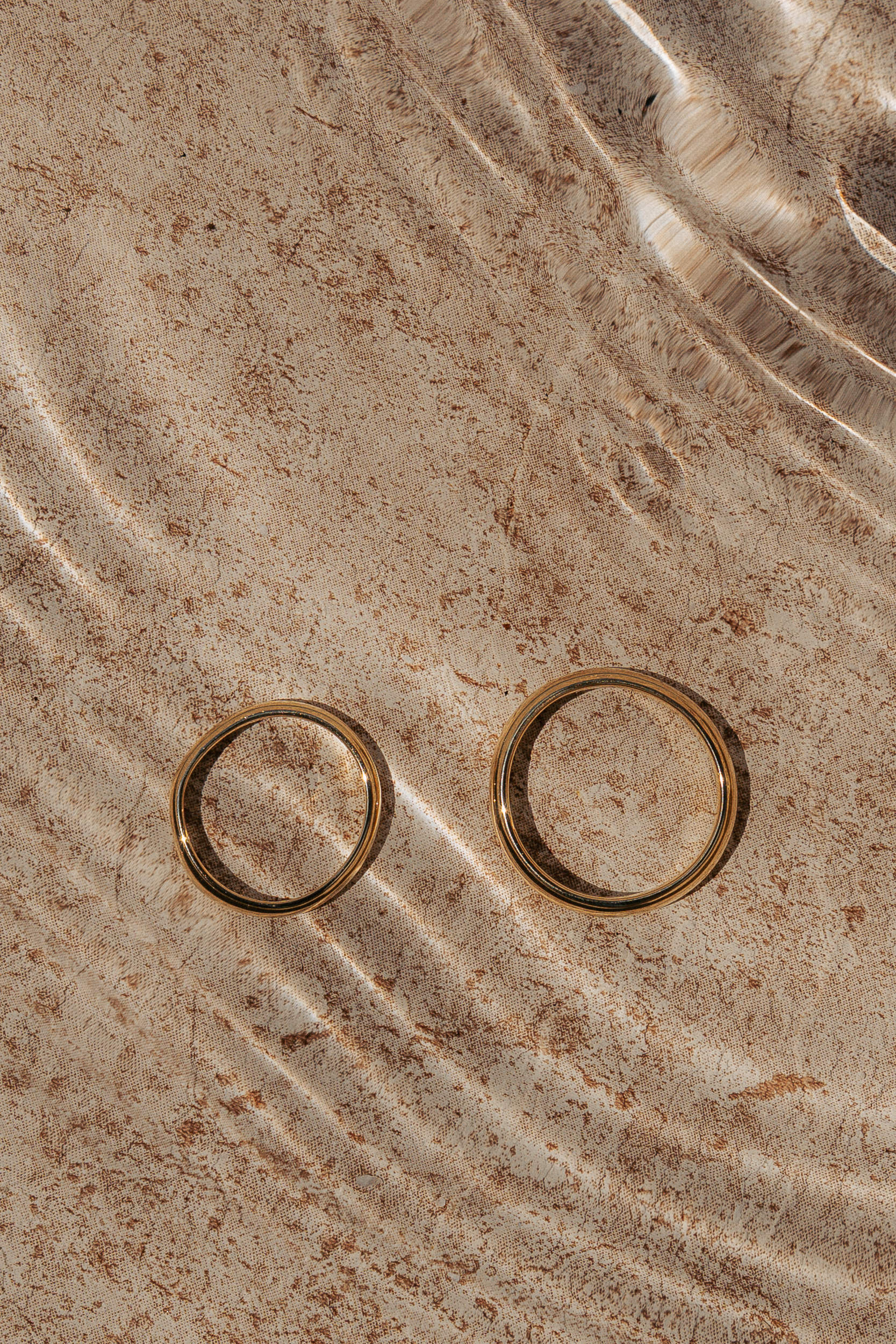 A serene outdoor scene featuring a stone structure adorned with colorful flowers cascading down the steps.