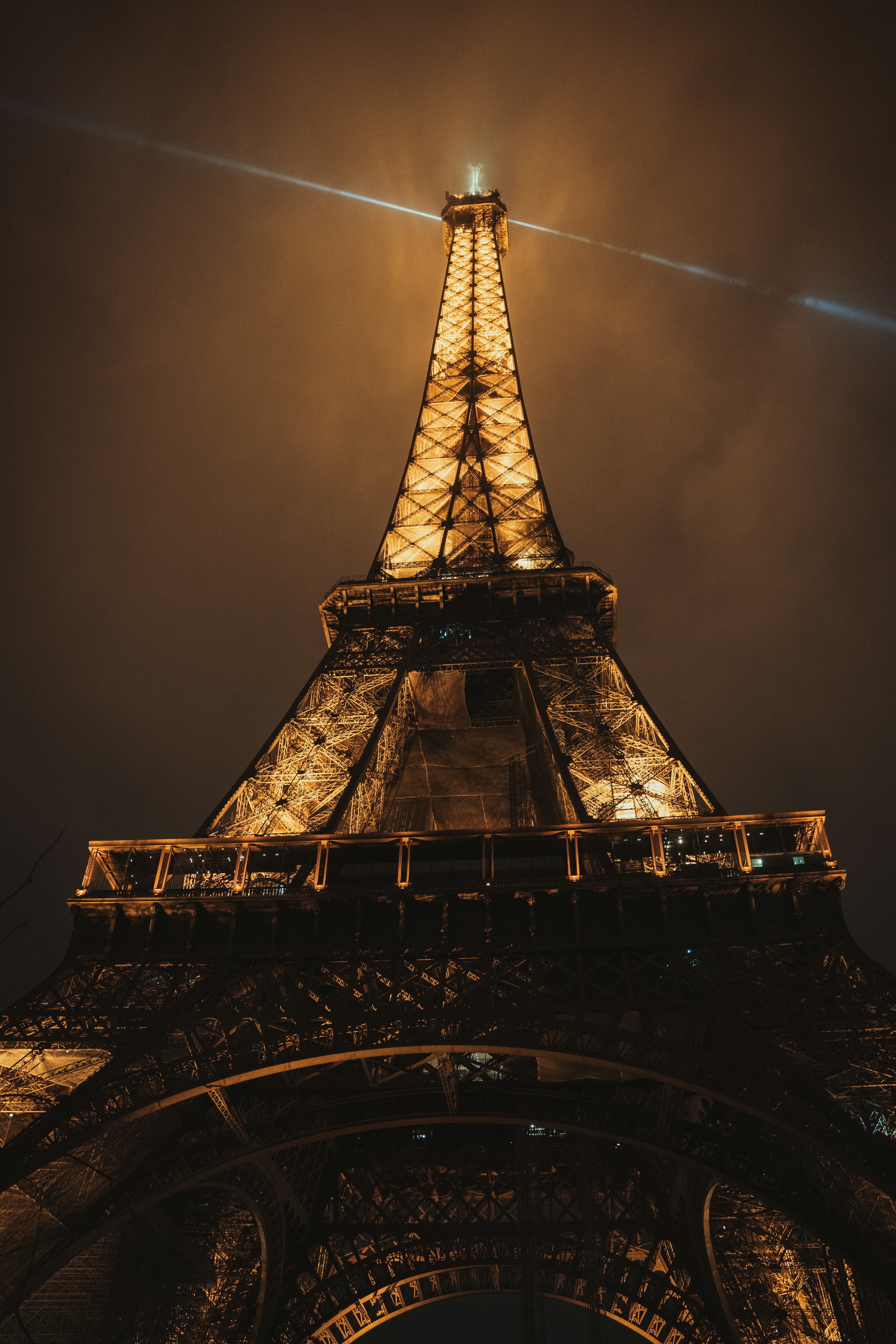 the eiffel tower is lit up at night