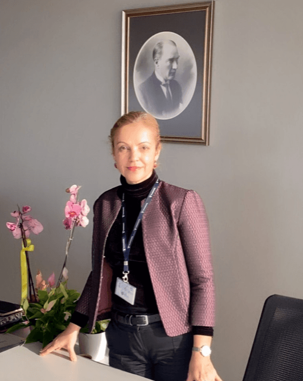 woman in black crew neck t-shirt wearing brown framed eyeglasses standing on rocky shore during