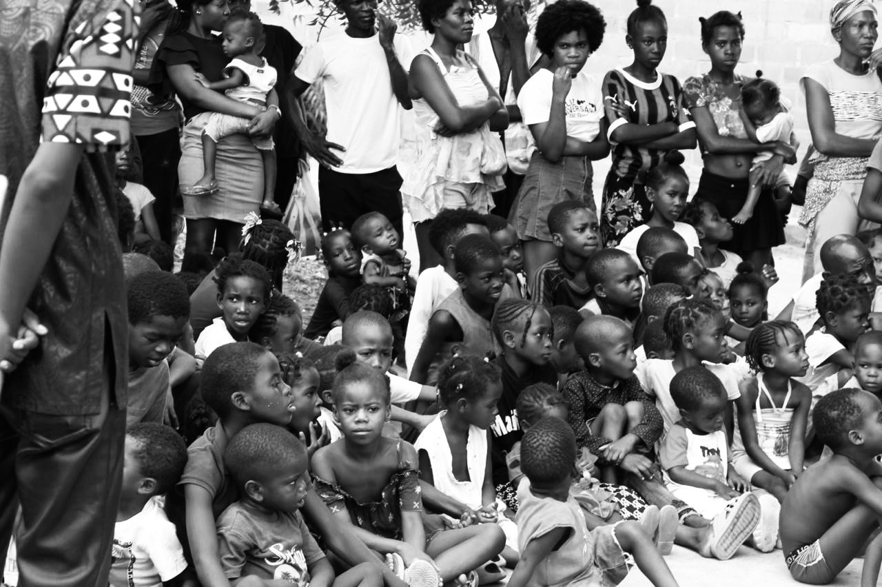 man in black crew neck t-shirt and blue shorts holding woman in white and red