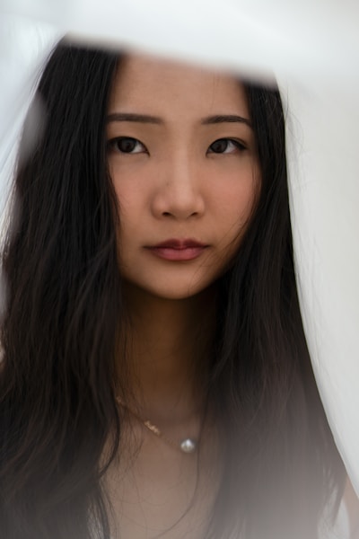A woman with long dark hair looking toward the camera.