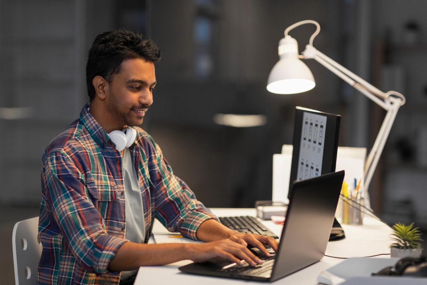 Bachelor of Computer Applications (BCA) representing a student or professional working on computer software and programming tasks on a laptop