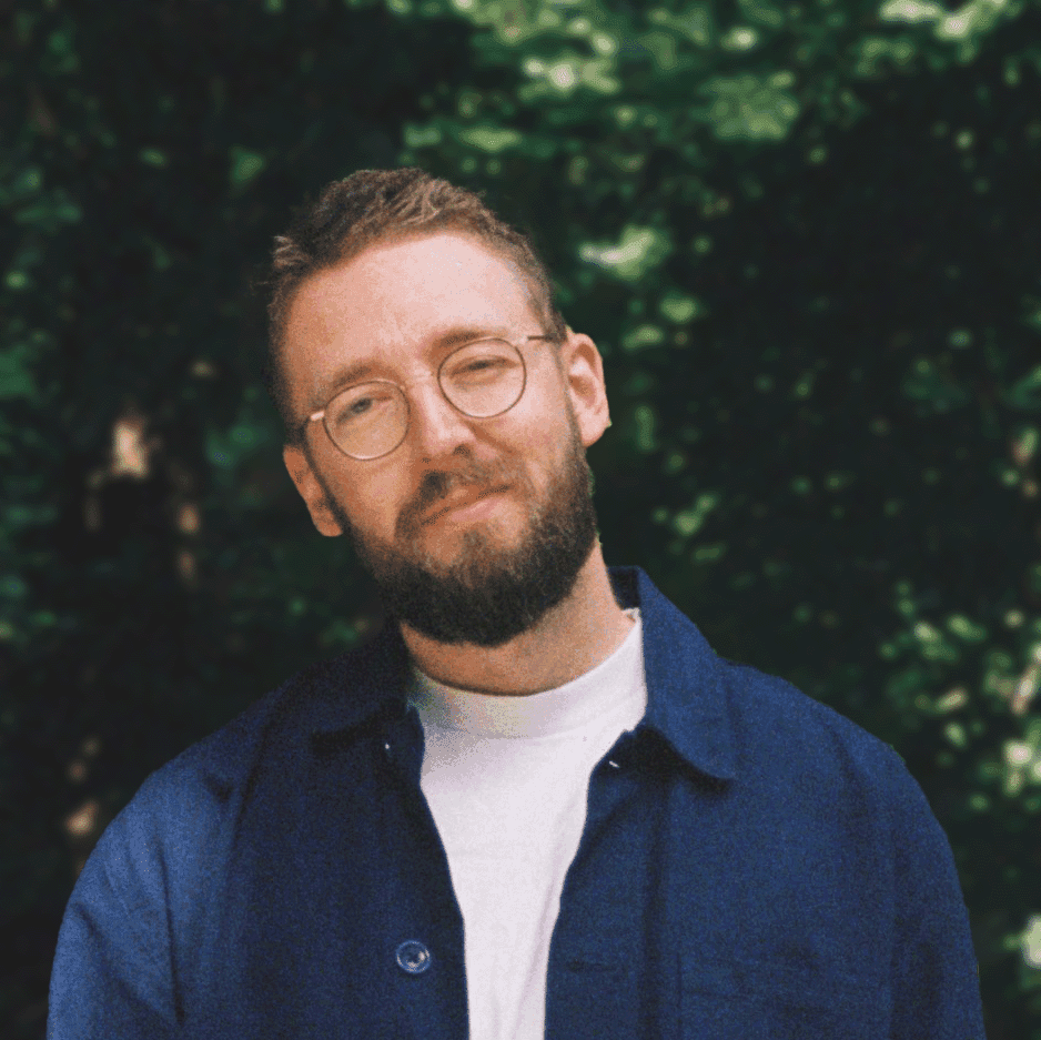 Close-up portrait of a young woman with long brown hair and blue eyes.