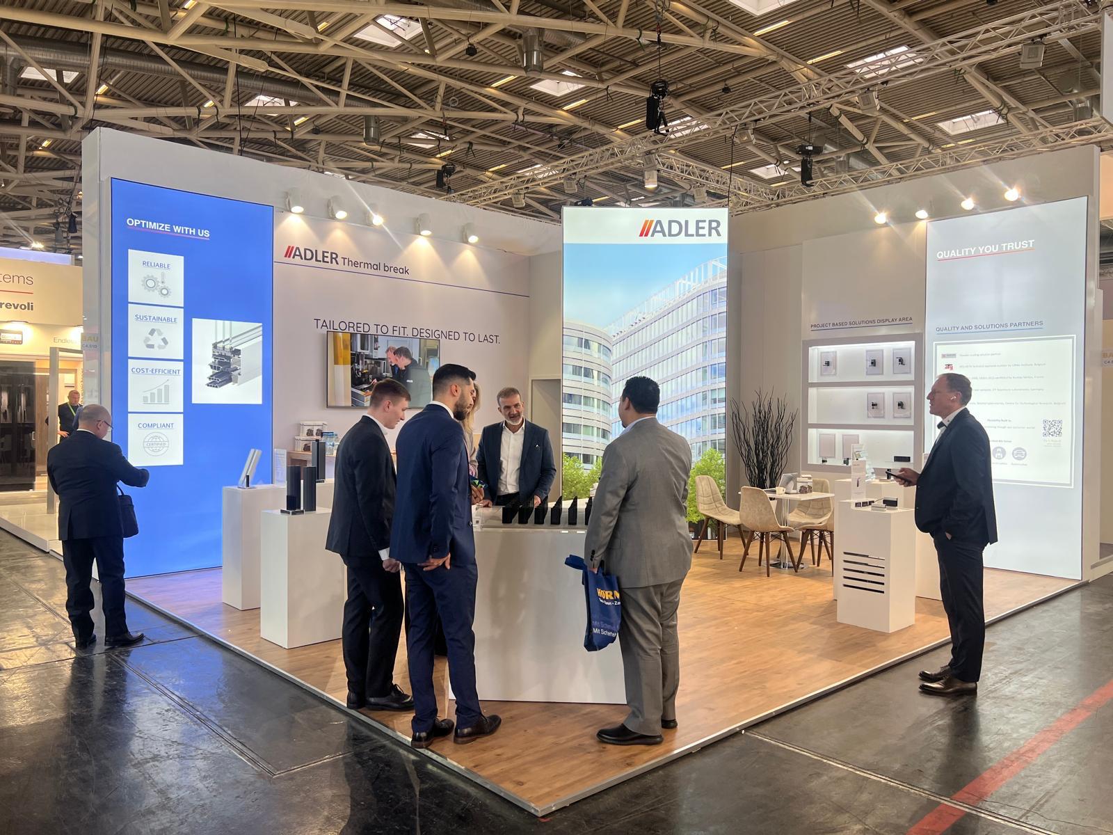 Product display pedestals at the Adler stand, showcasing thermal break profiles for aluminium windows, doors, and façade systems.