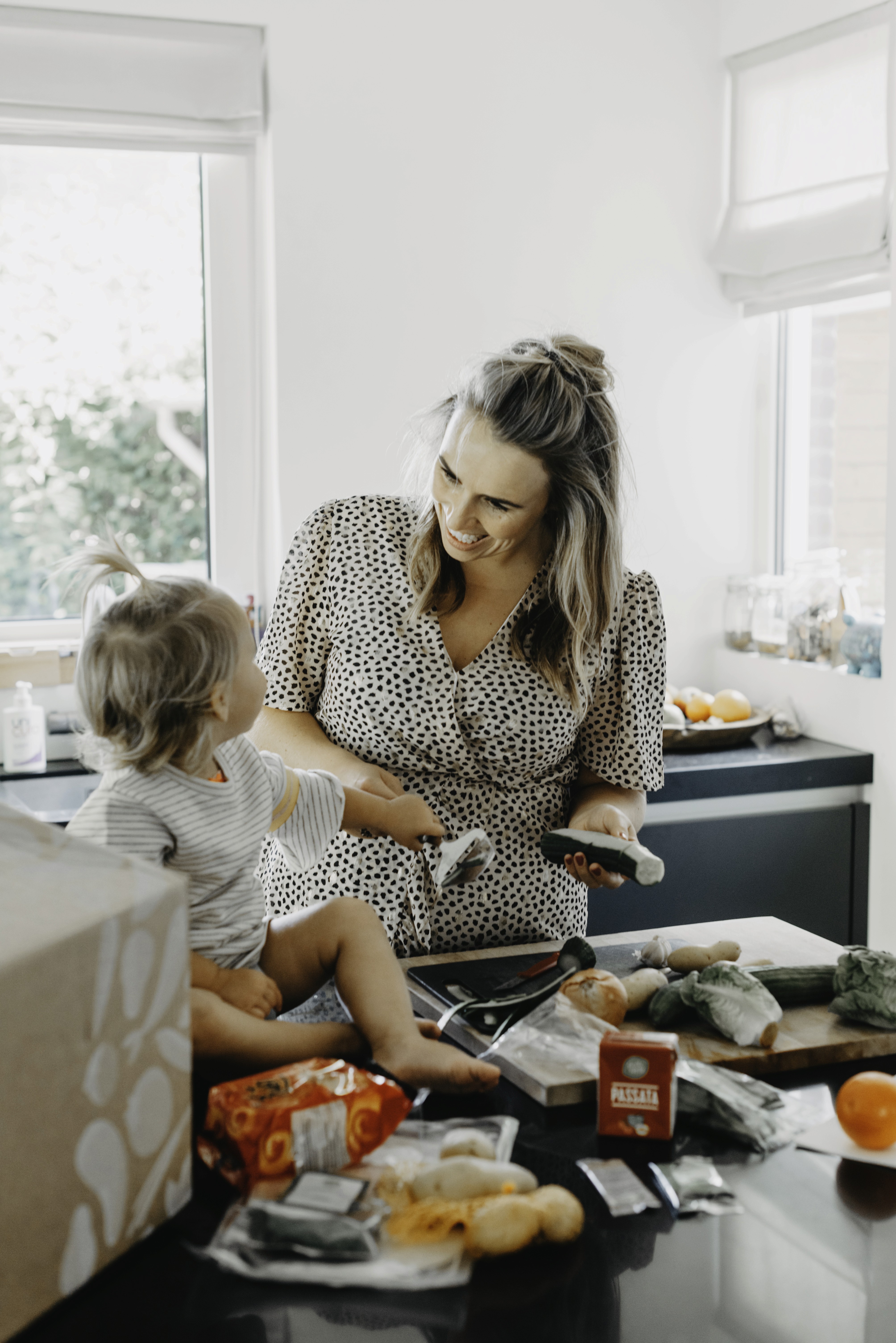 The babysitter cooks a fresh meal.