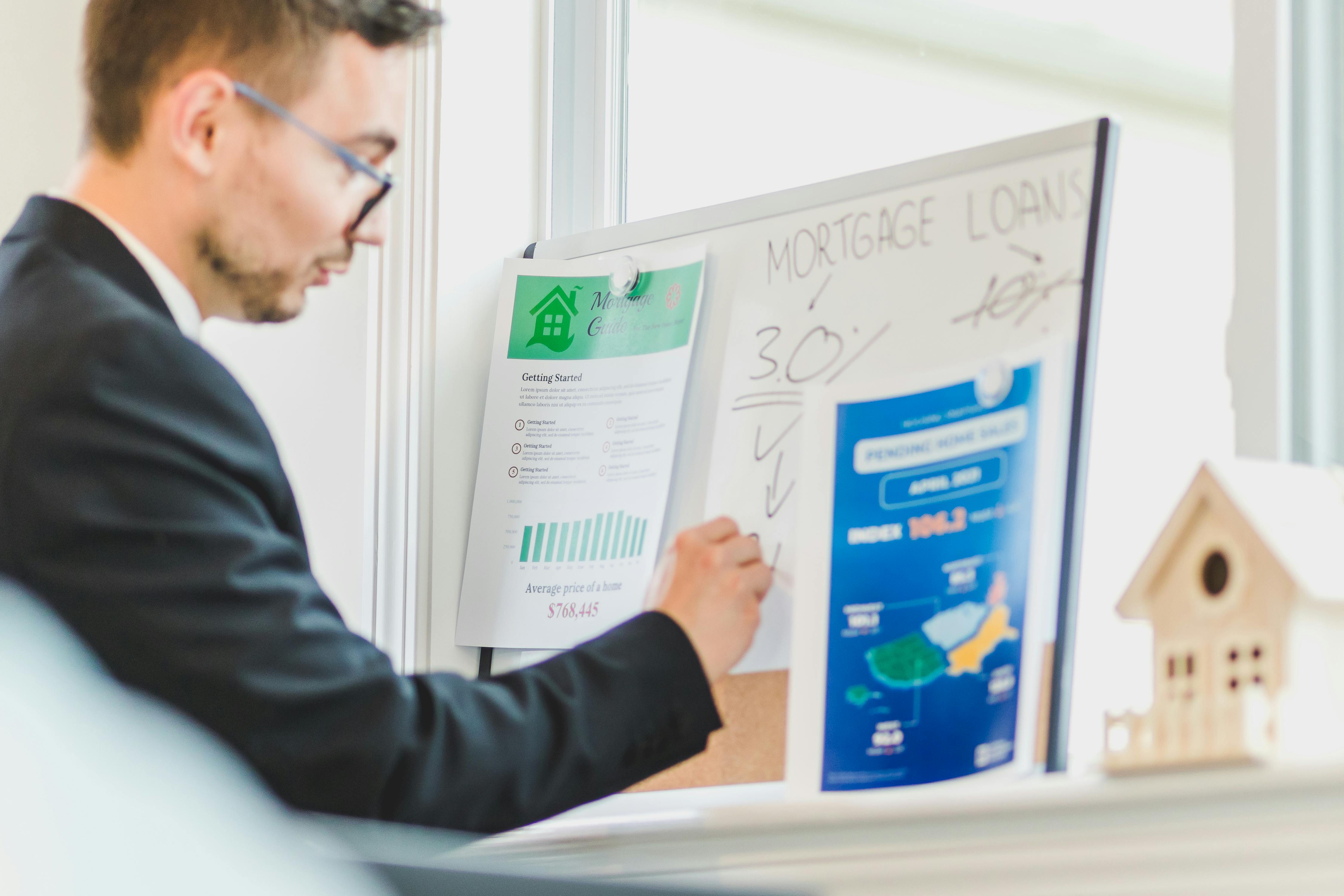 Man writing on white board about mortgage loan