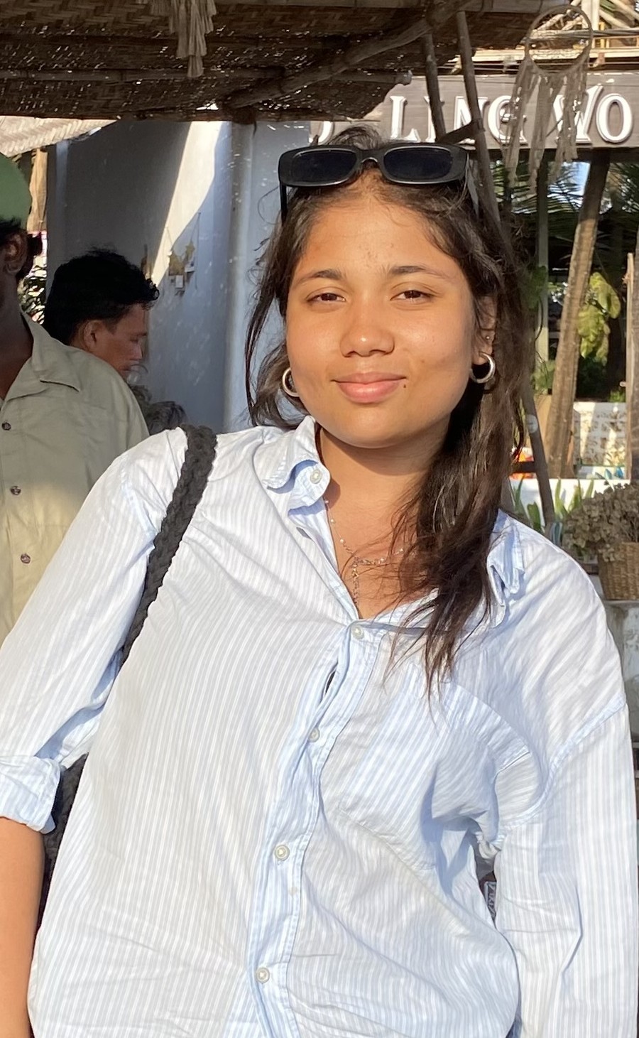 A woman with red hair is standing in the grass