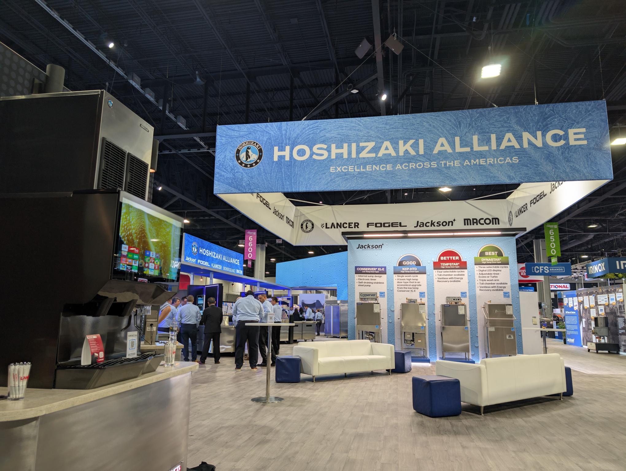 A team of professionals collaborates around a table, discussing documents in a focused and dynamic setting.