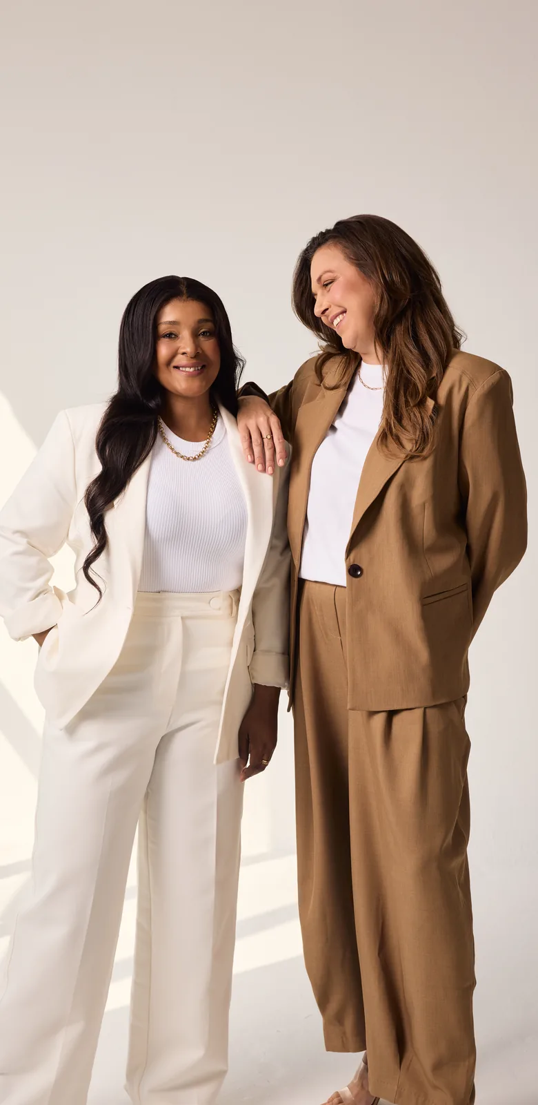Sēkret founders Roz and Zola standing together in a bright studio